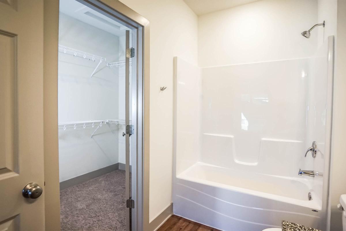 a white tub sitting next to a shower