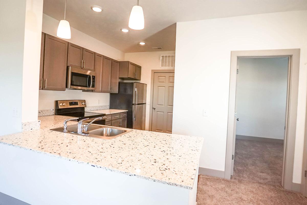 a kitchen with a sink and a mirror