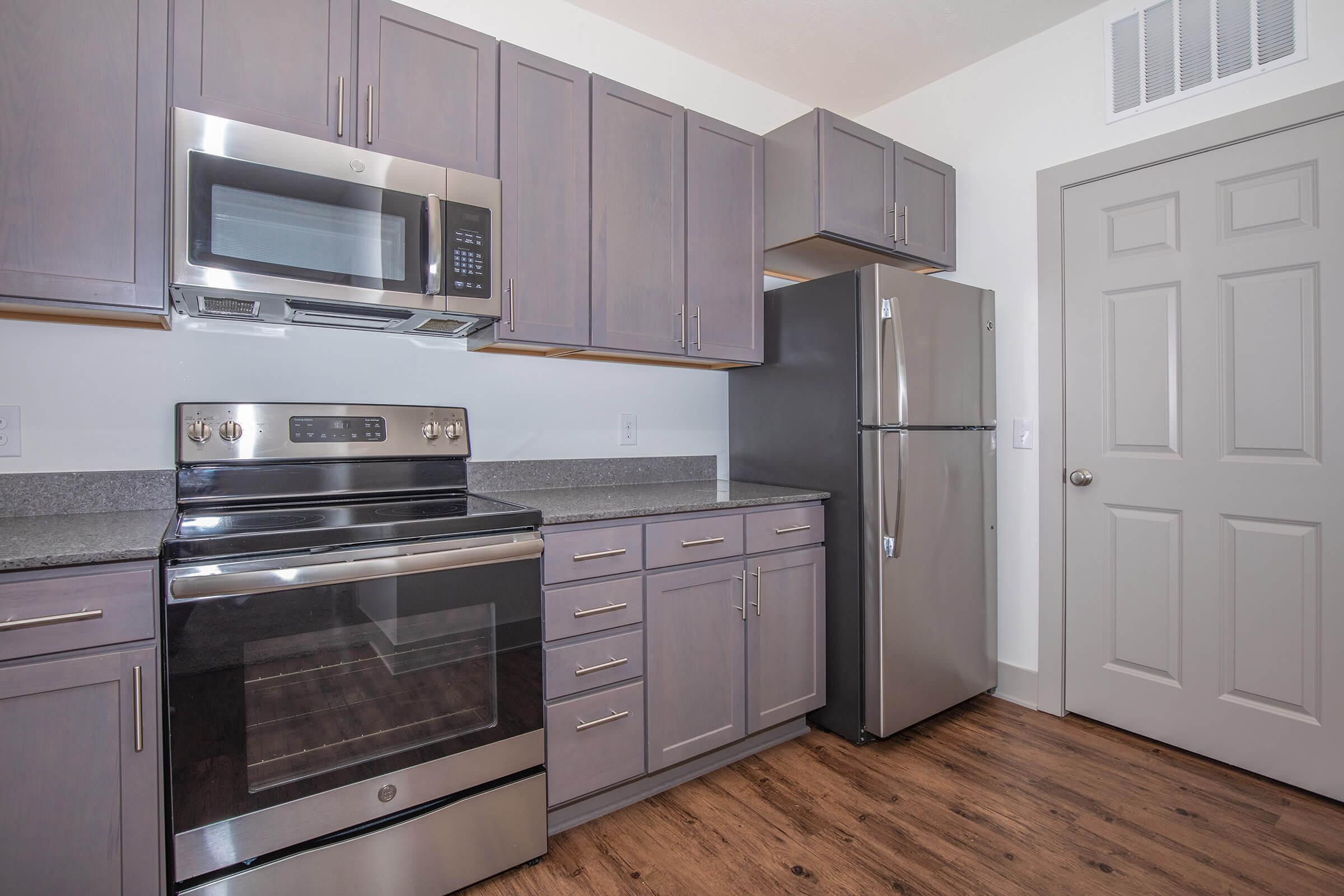 a stove top oven sitting inside of a kitchen