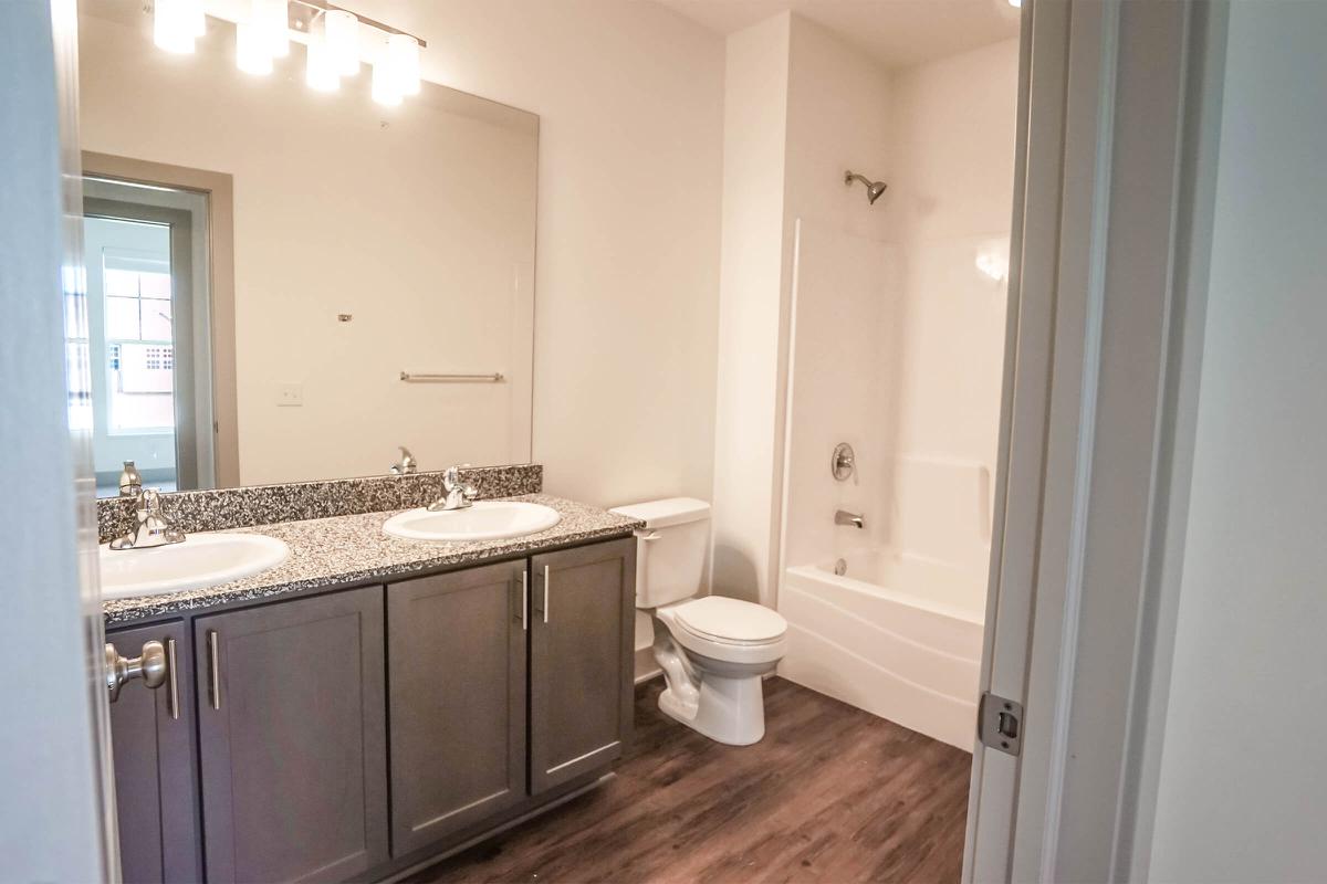 a kitchen with a sink and a mirror