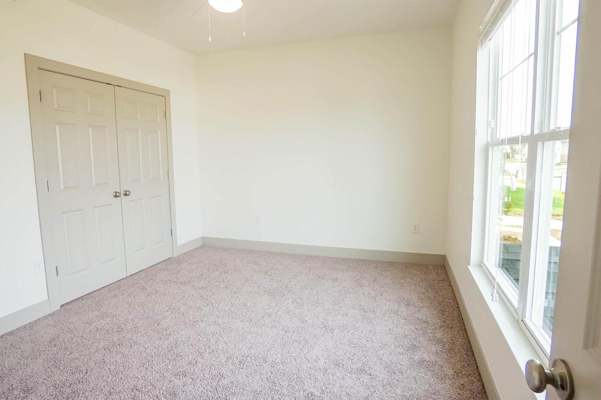 a bedroom with a large window