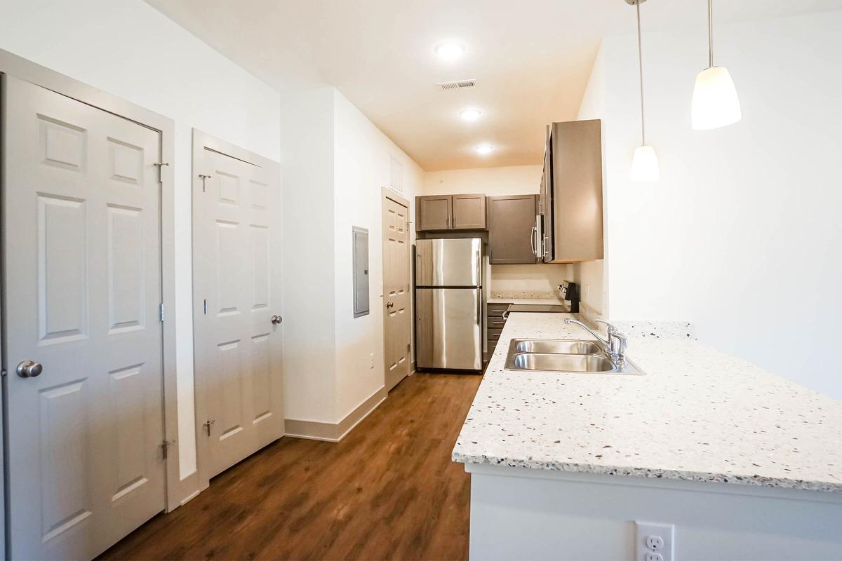 a bedroom with a view of a kitchen