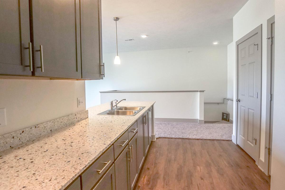 a kitchen with a sink and a mirror