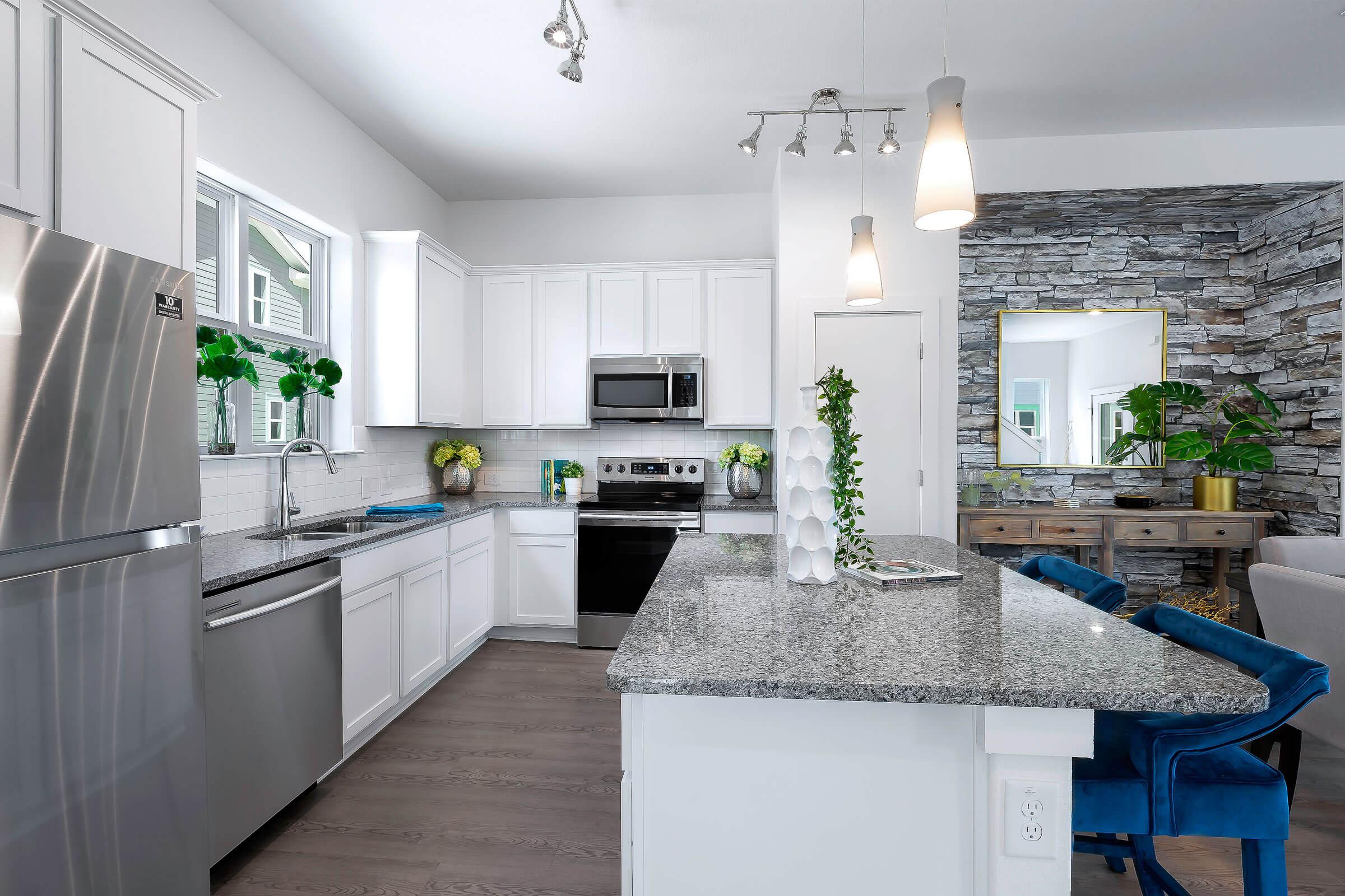 a modern kitchen with white cabinets