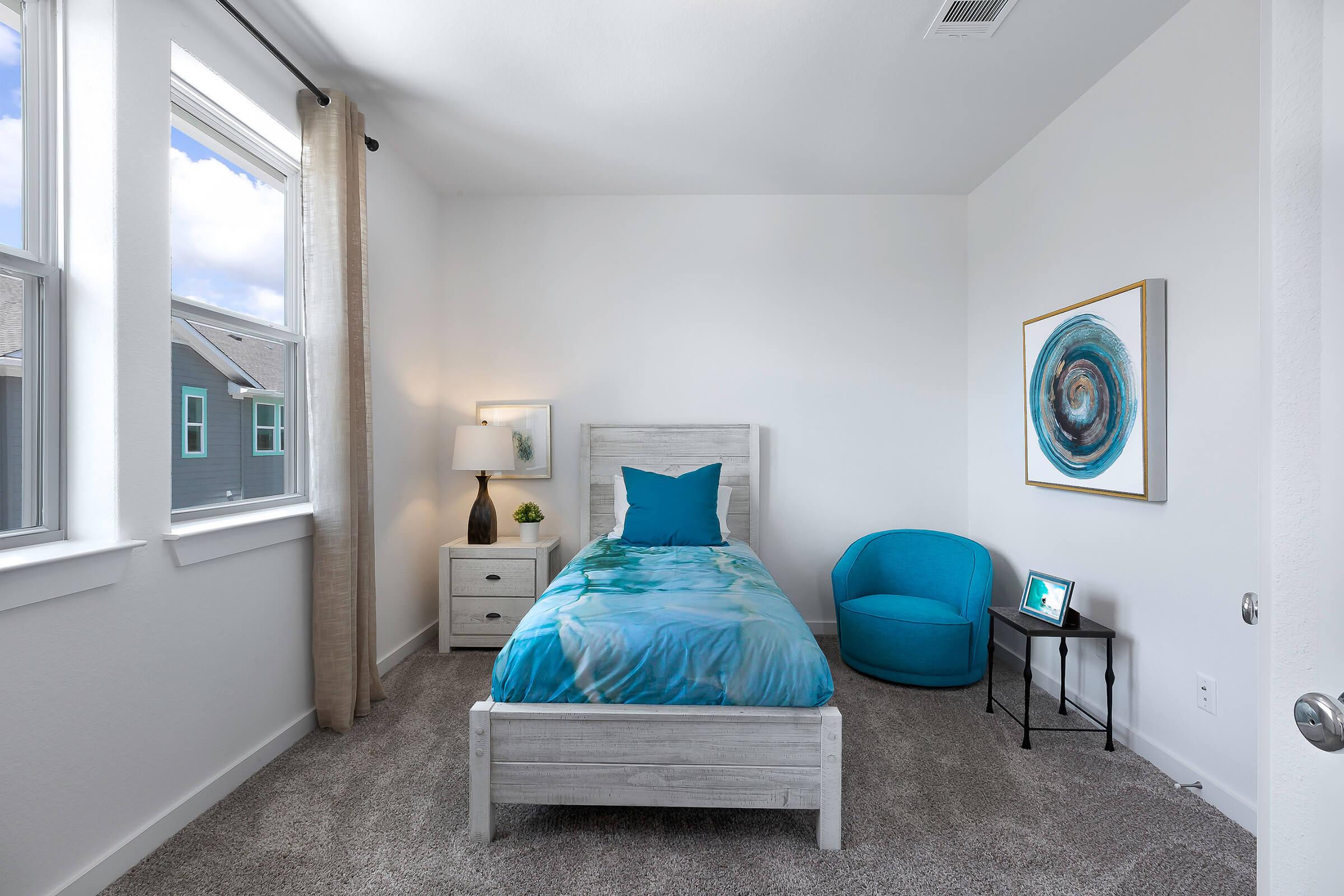 a blue and white bed in a room