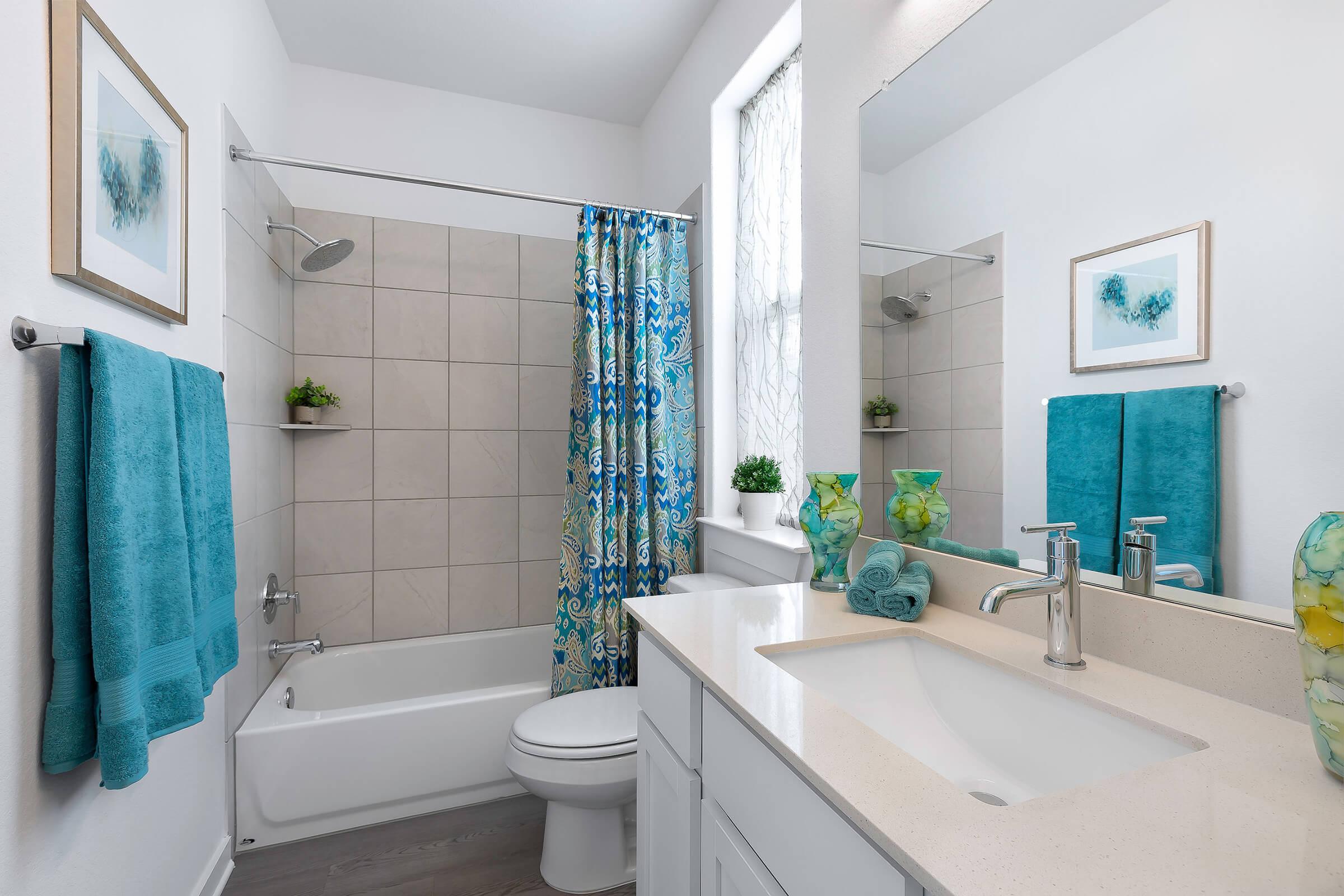 a large white tub sitting next to a sink