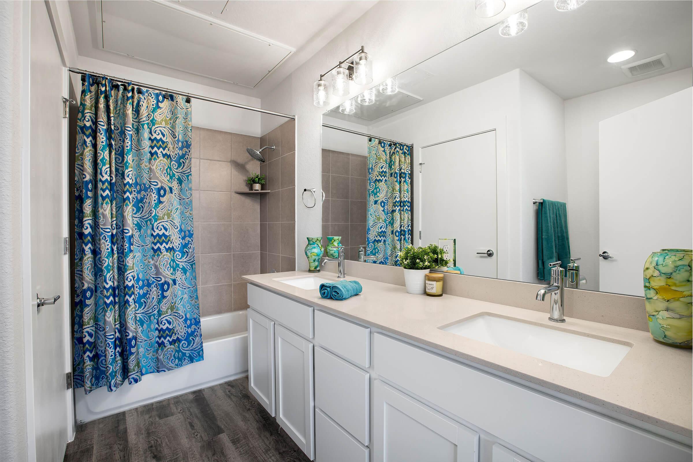 a shower curtain next to a sink