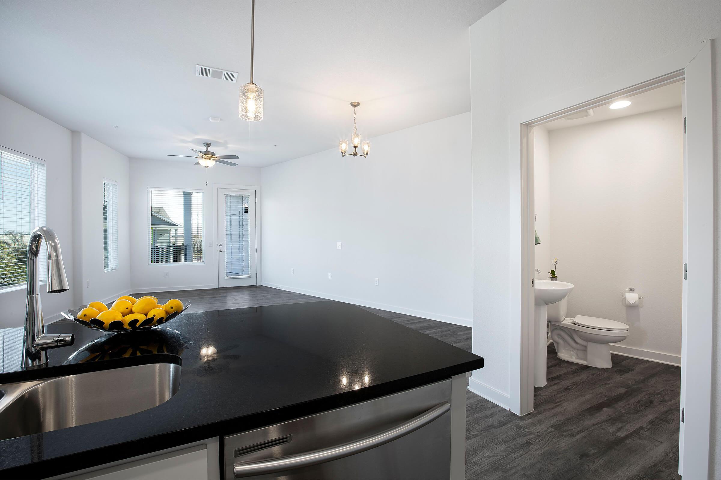 a kitchen with a sink and a mirror