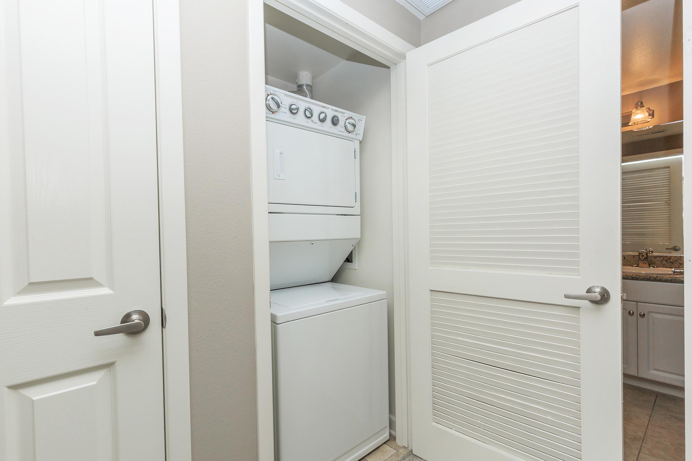 Stacked washer and dryer in closet