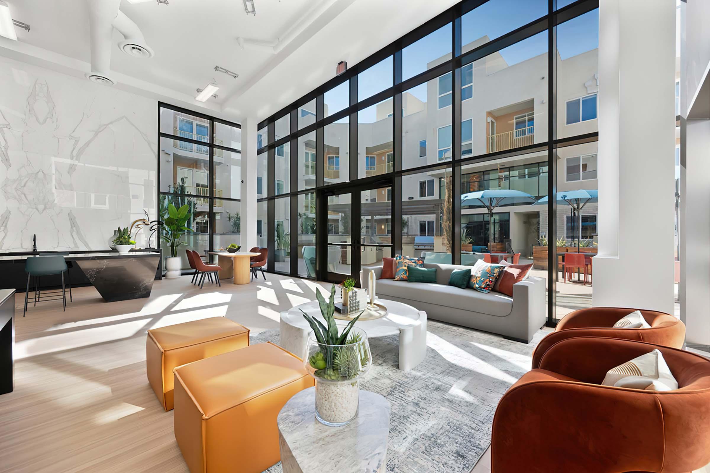 a living room filled with furniture and a large window