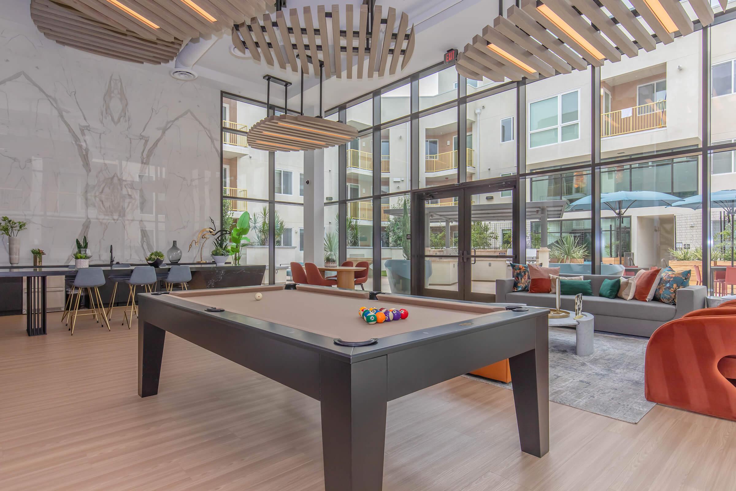 a living room filled with furniture and a table in front of a building