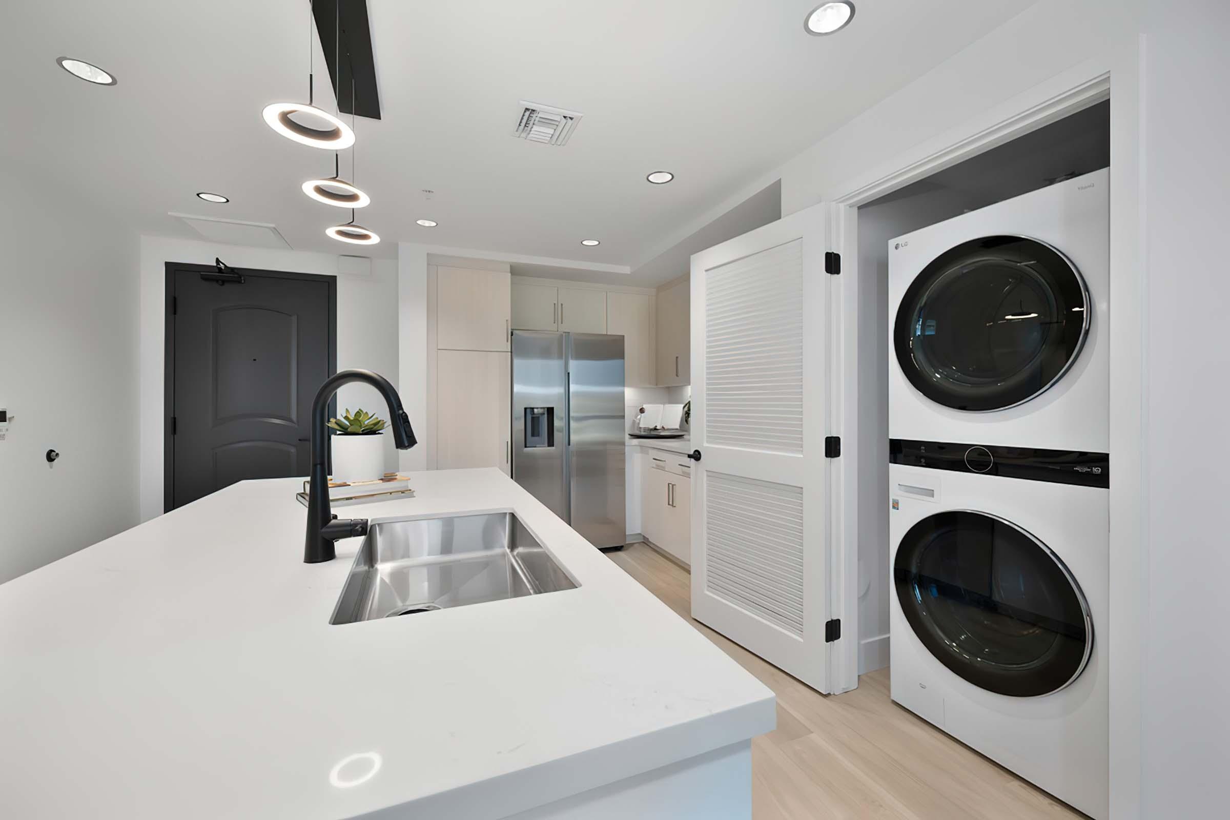 a kitchen with a sink and a mirror