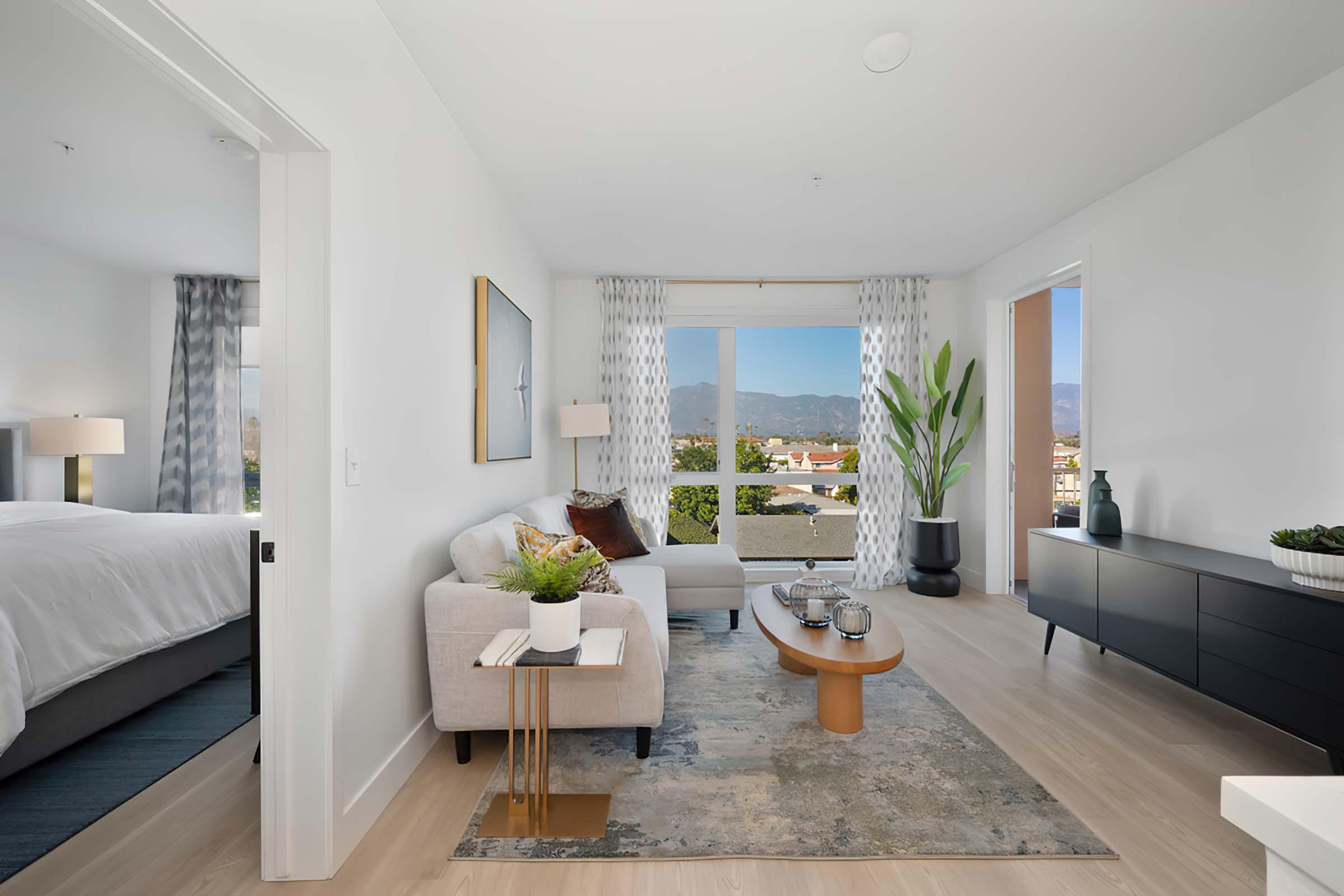 a living room filled with furniture and a large window