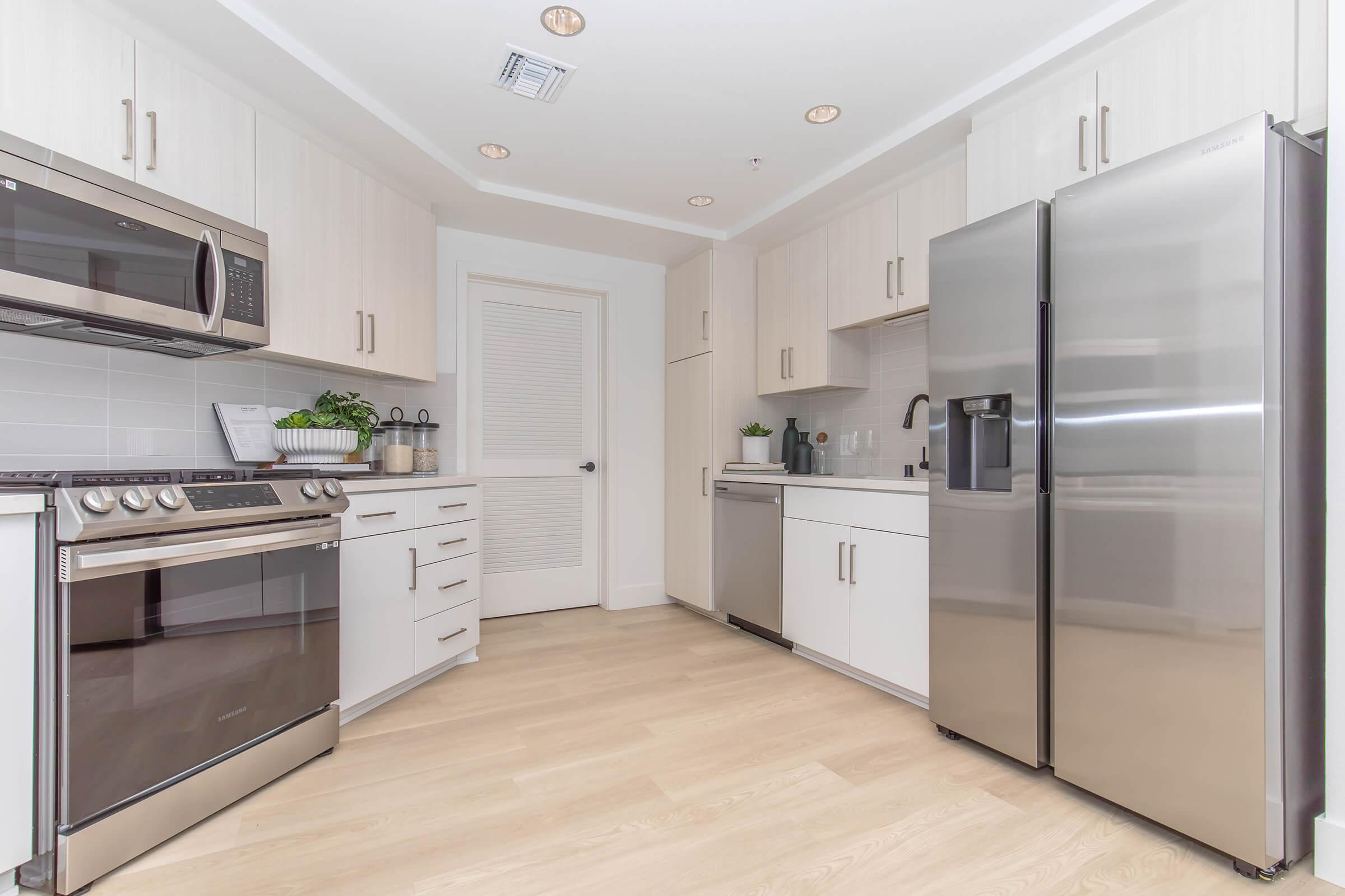 a kitchen with a stove sink and refrigerator