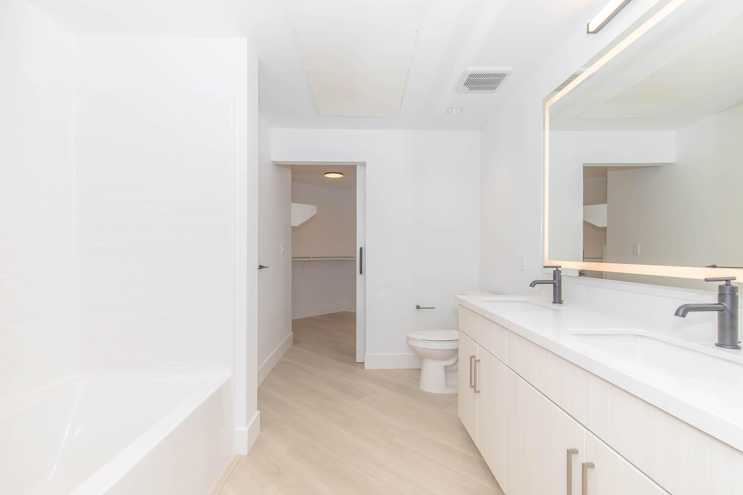 a kitchen with a sink and a mirror