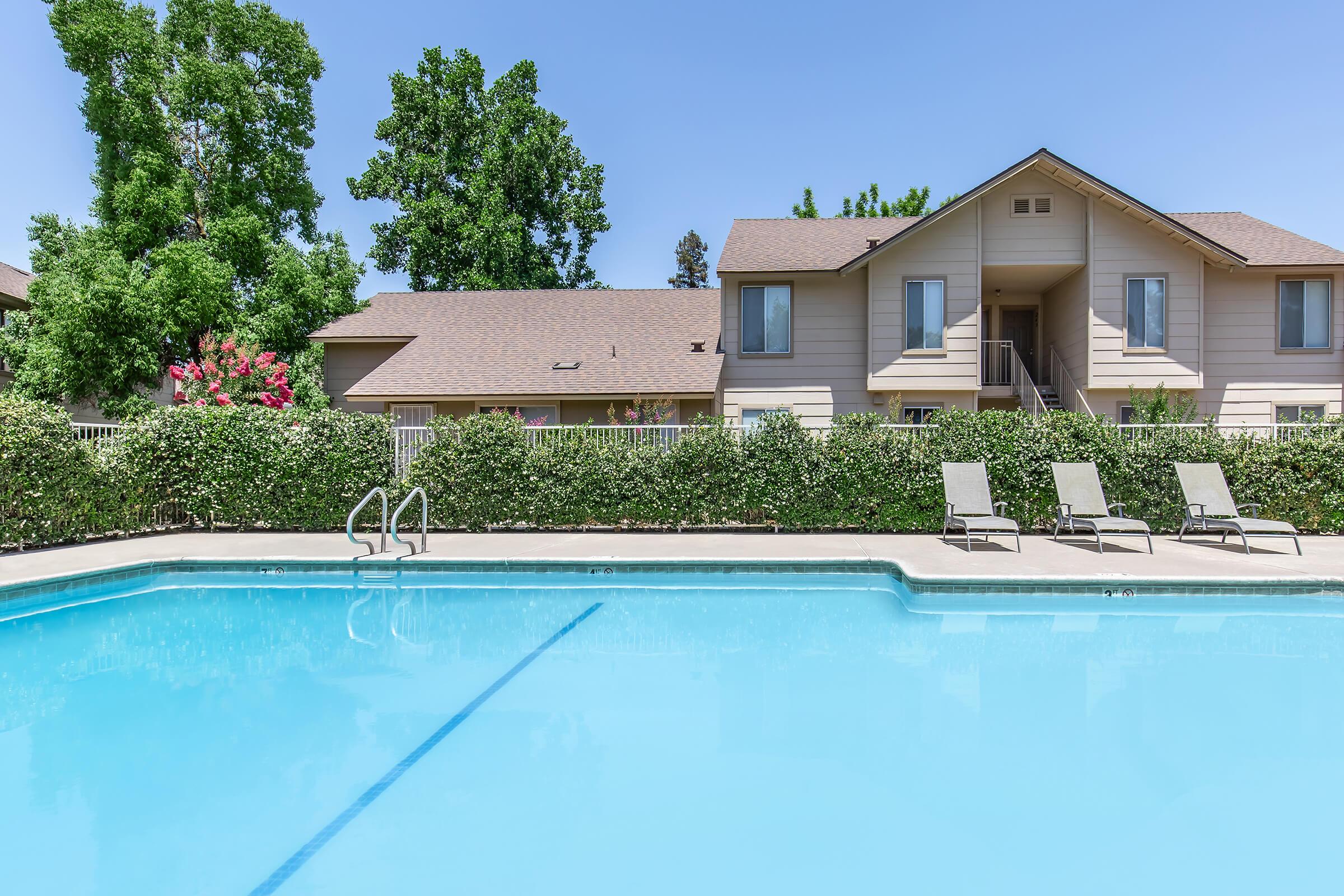 a blue pool of water in front of a house