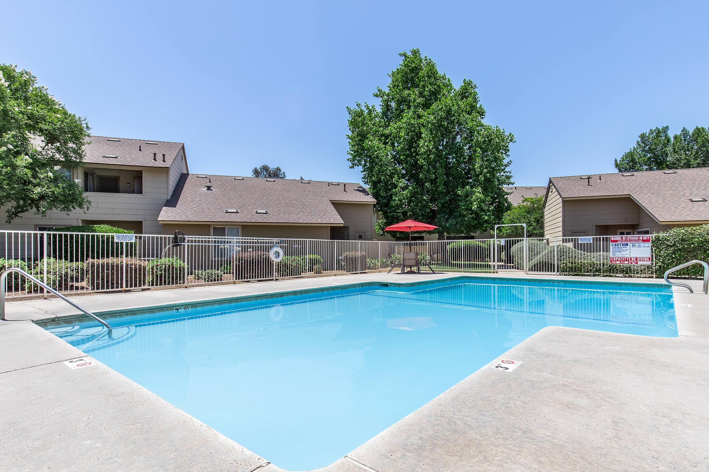 a house with a pool in front of a building