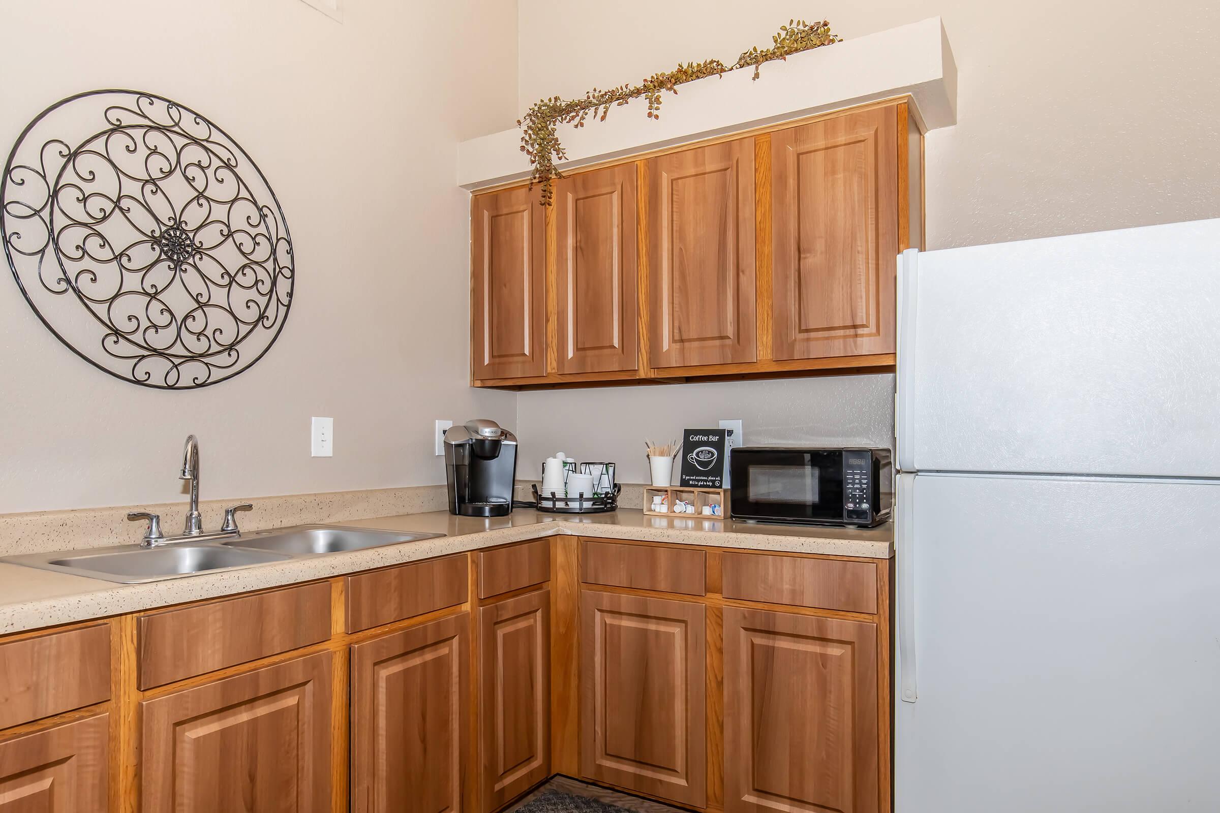 a kitchen with wooden cabinets