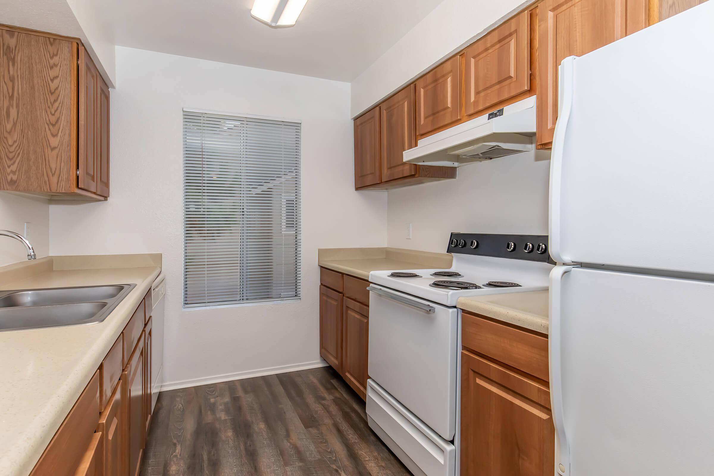 a kitchen with a stove sink and refrigerator