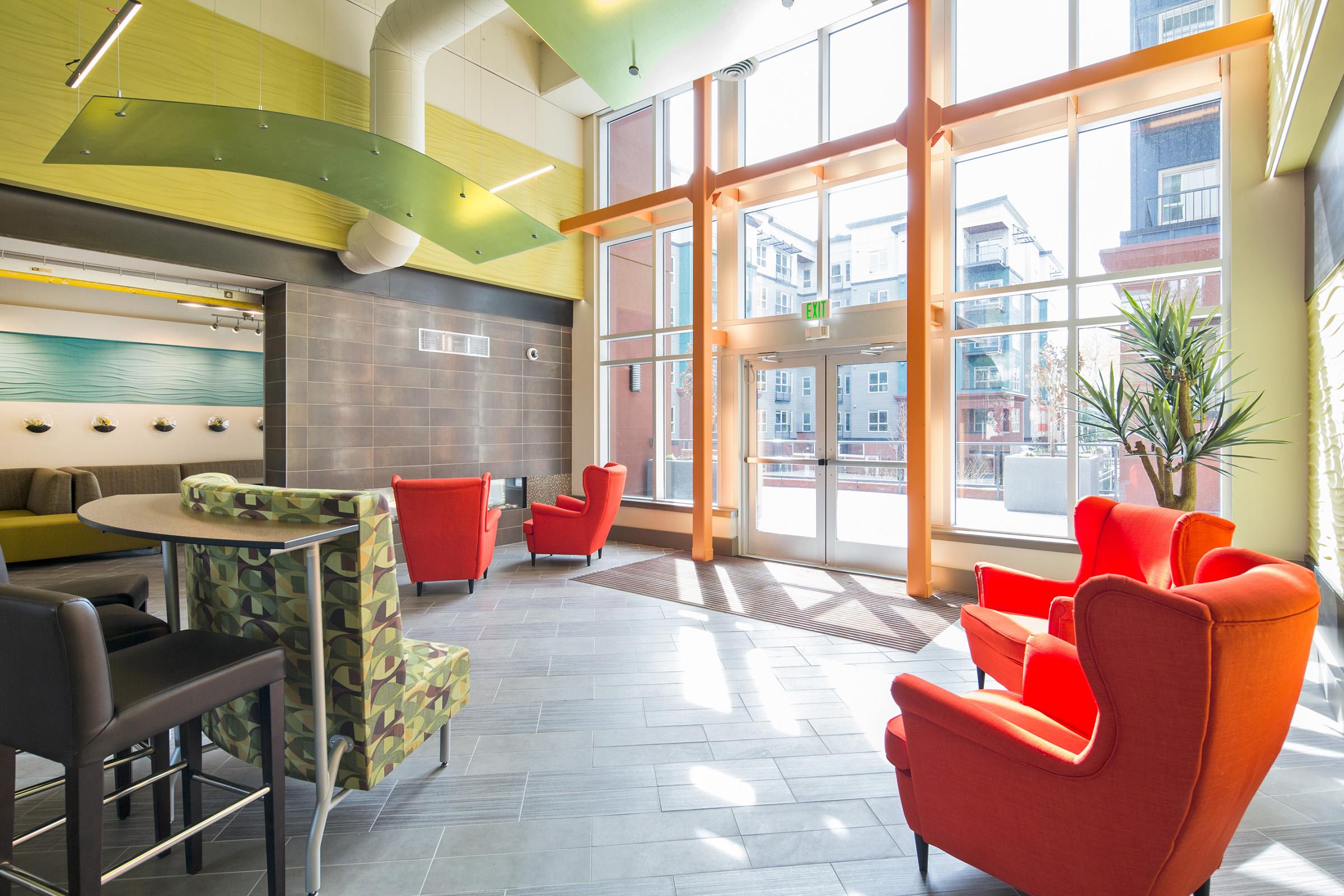 A modern lobby area featuring large windows that allow natural light to shine in.