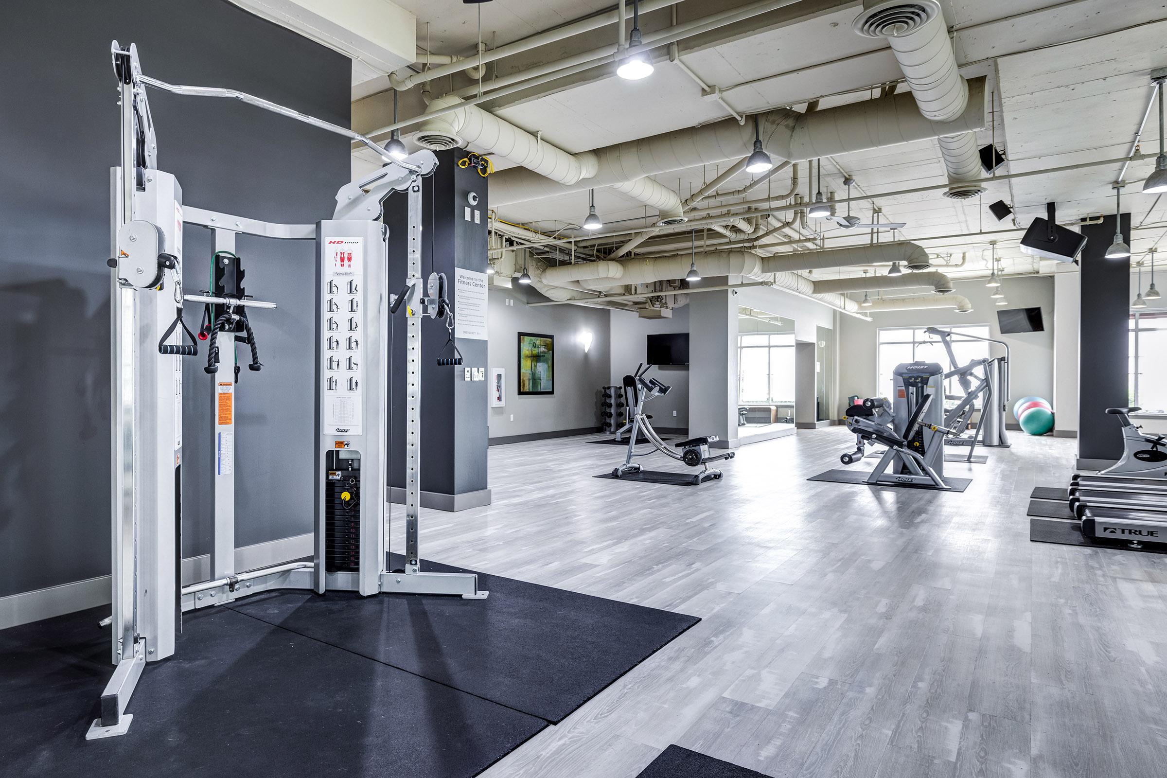 Modern gym interior featuring various workout equipment.