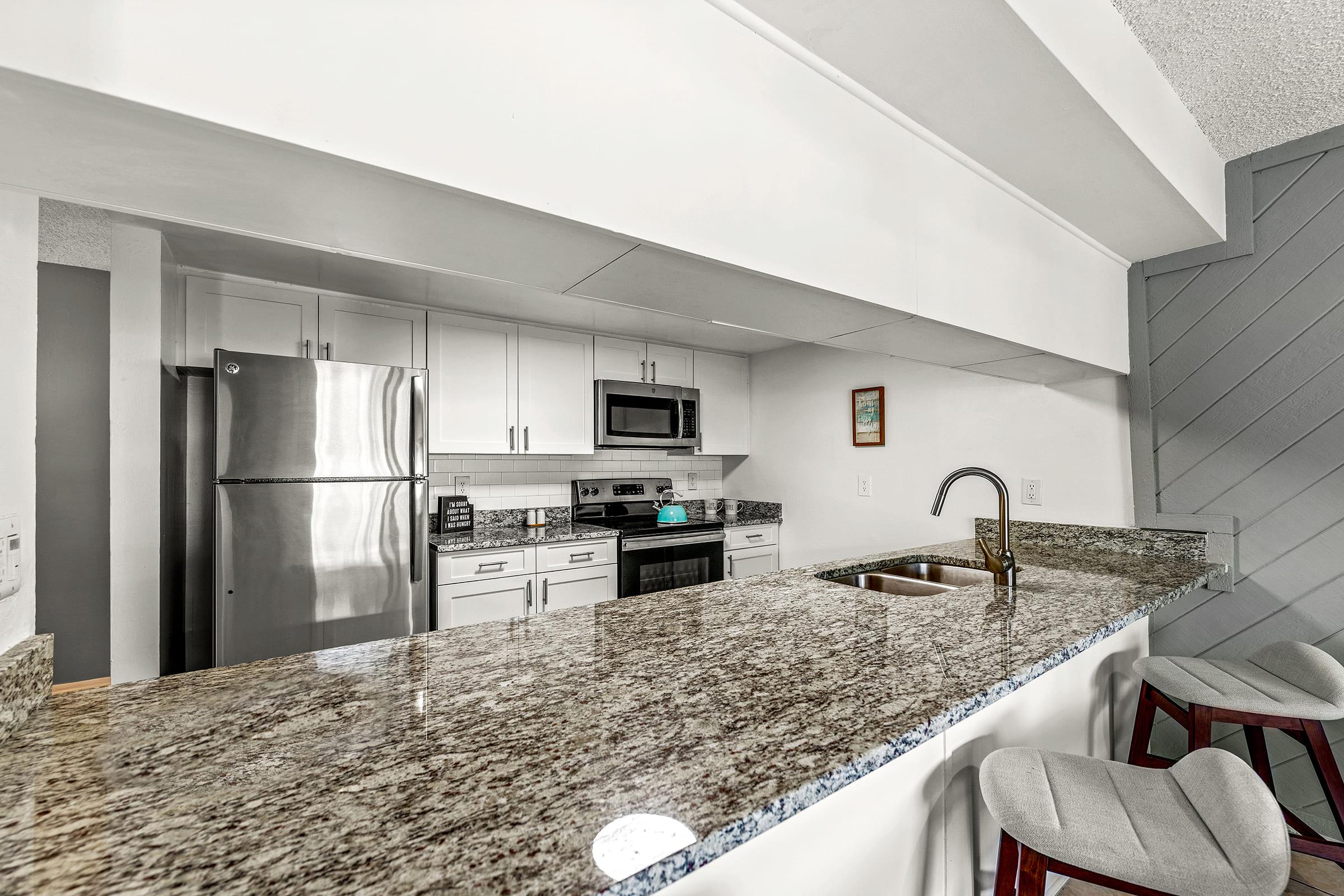 a kitchen with a sink and a refrigerator