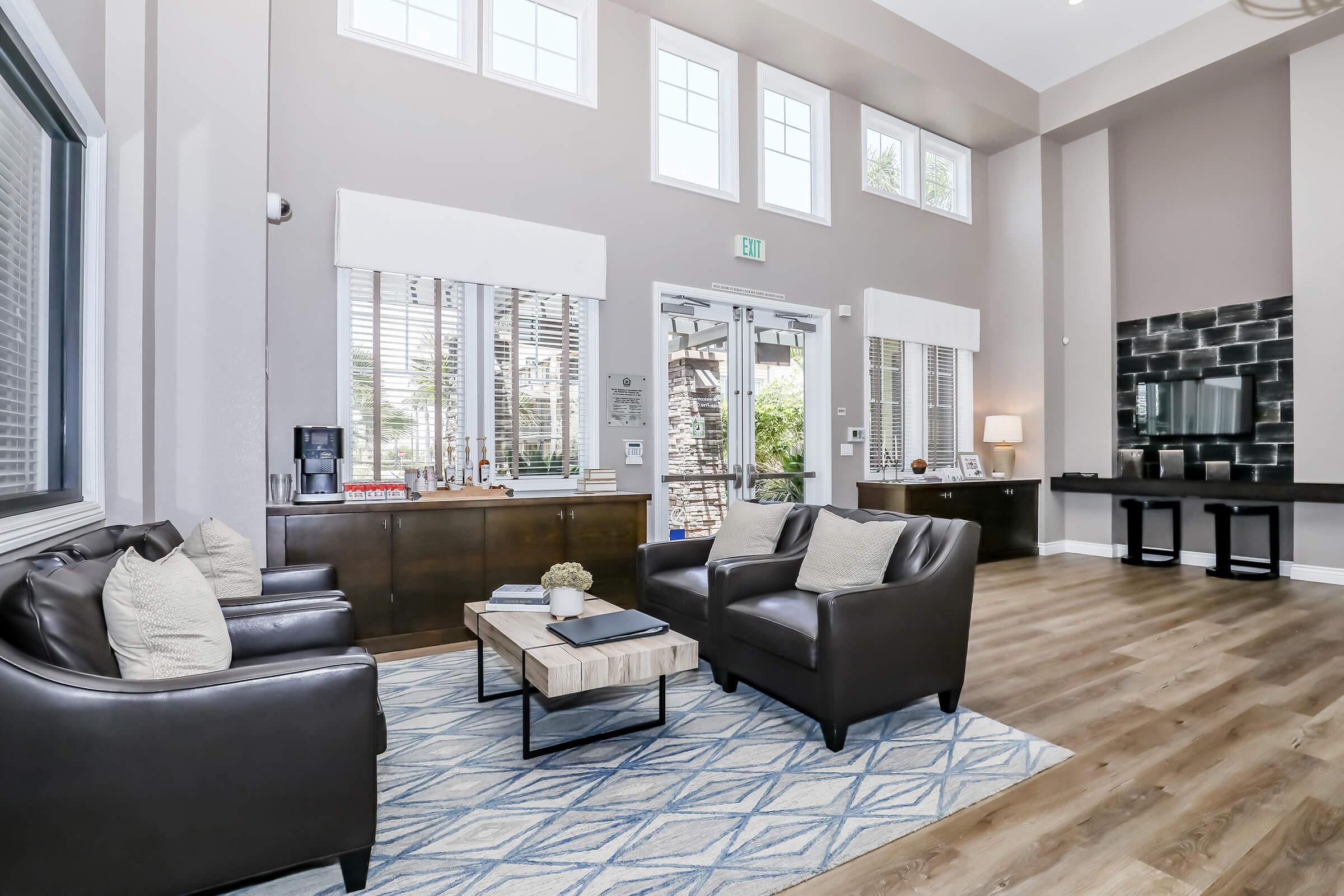 a living room filled with furniture and a large window