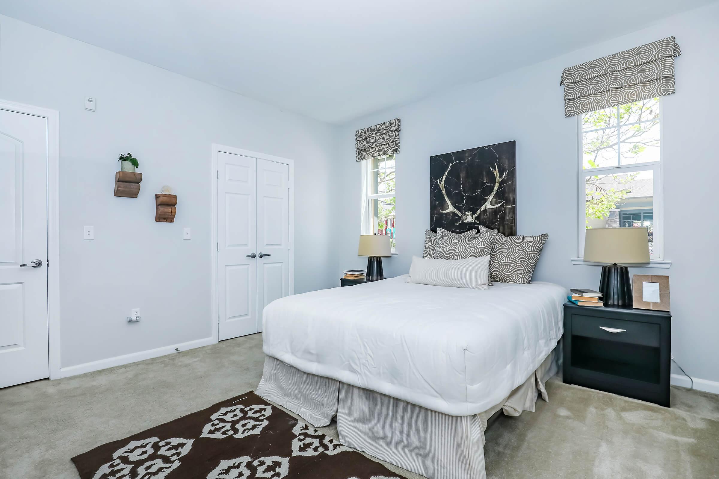 a bedroom with a bed and desk in a room