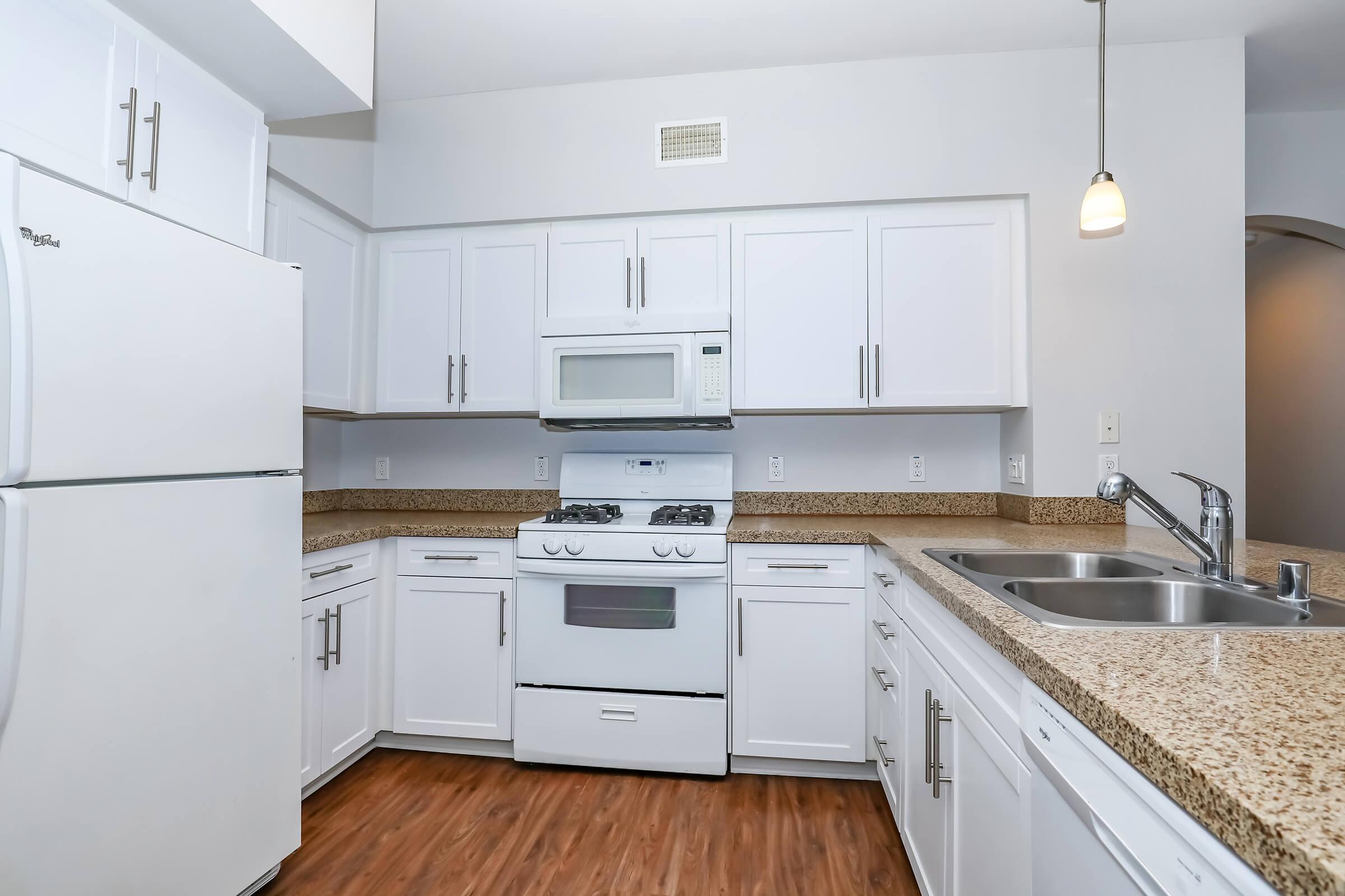 a kitchen with a stove and a refrigerator