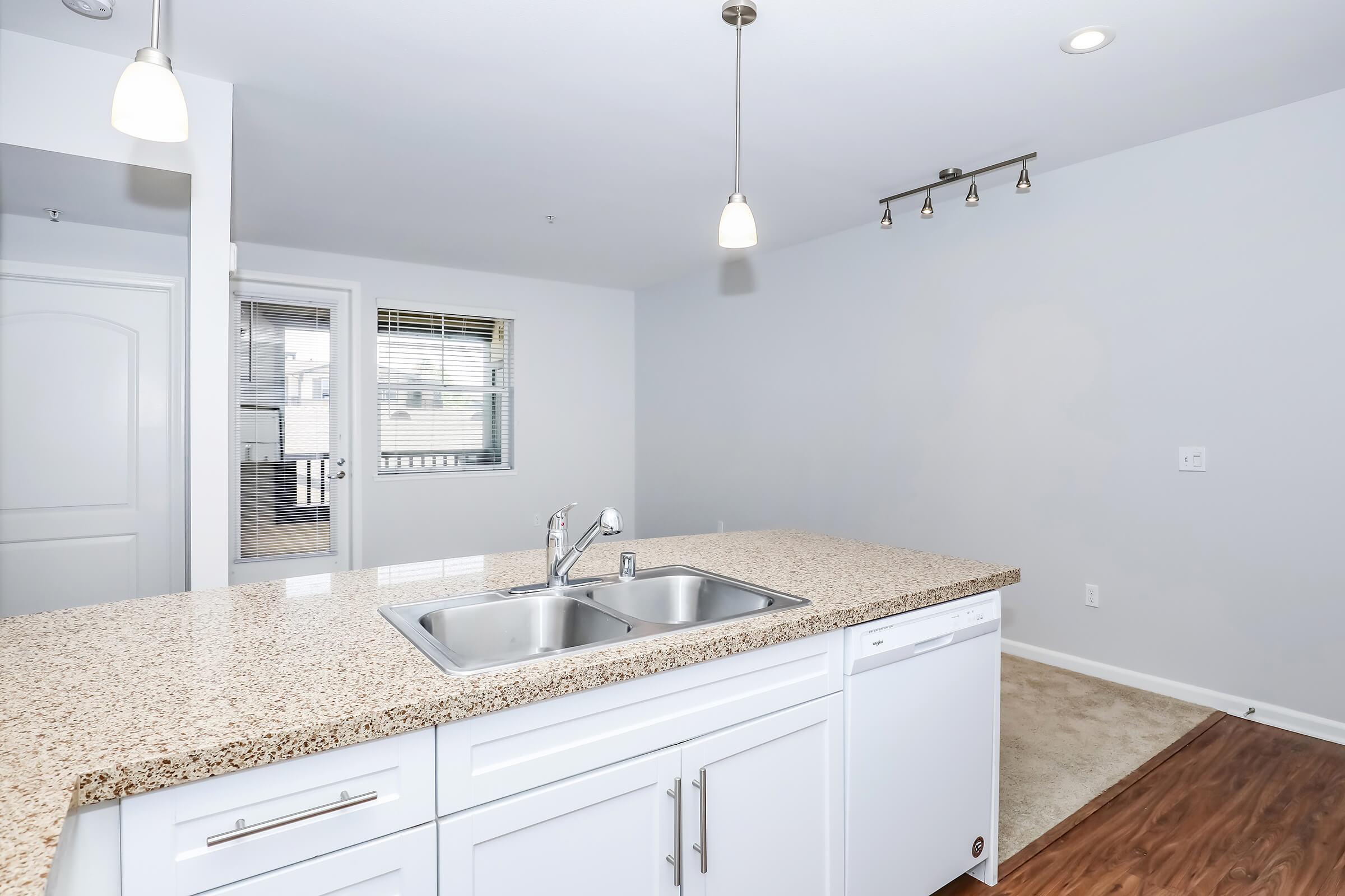 a kitchen with a sink and a mirror