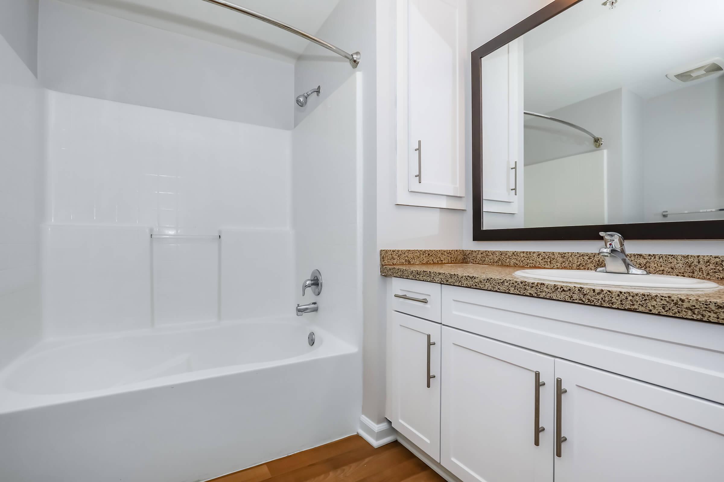 a kitchen with a sink and a mirror