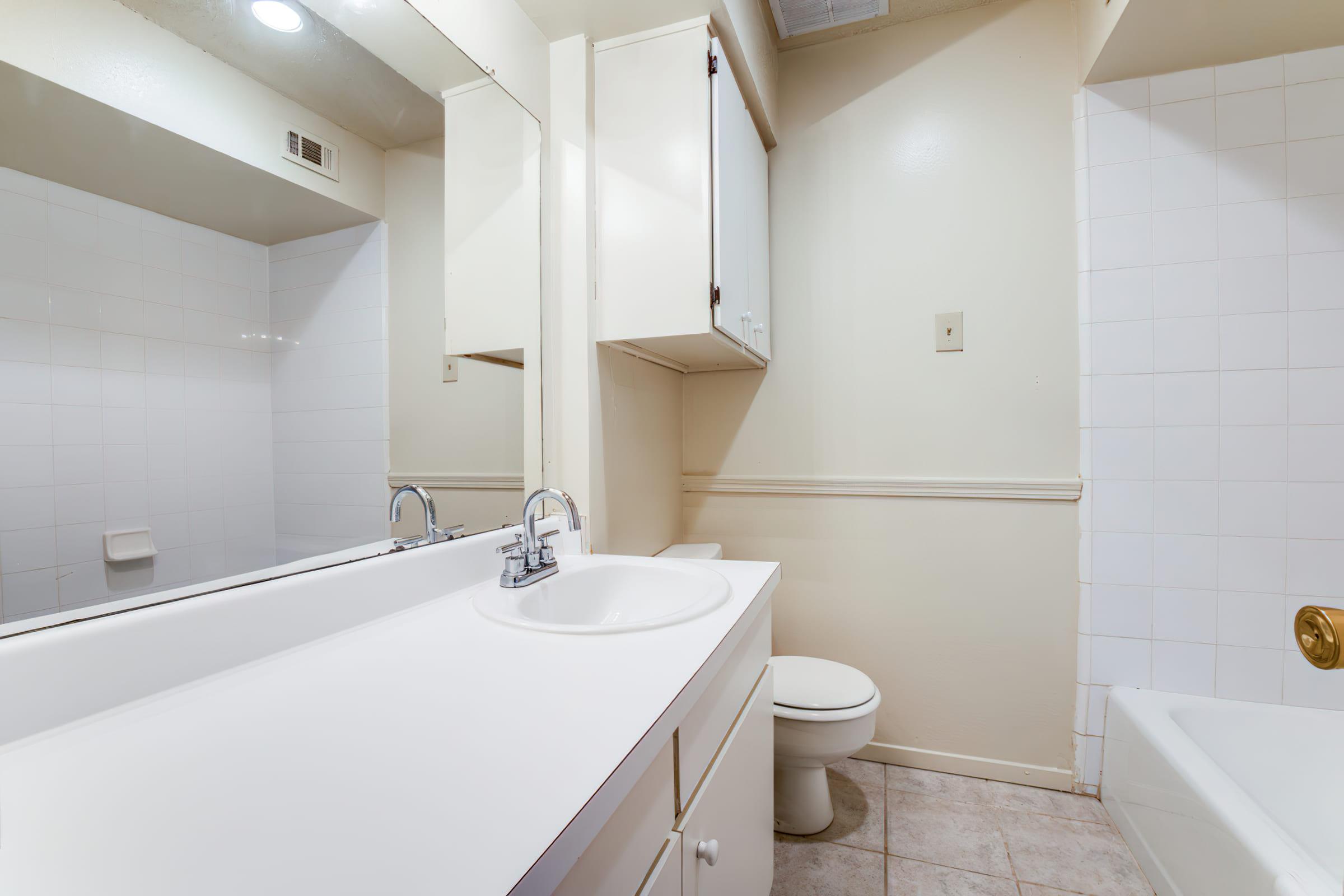 vacant bathroom with white countertops