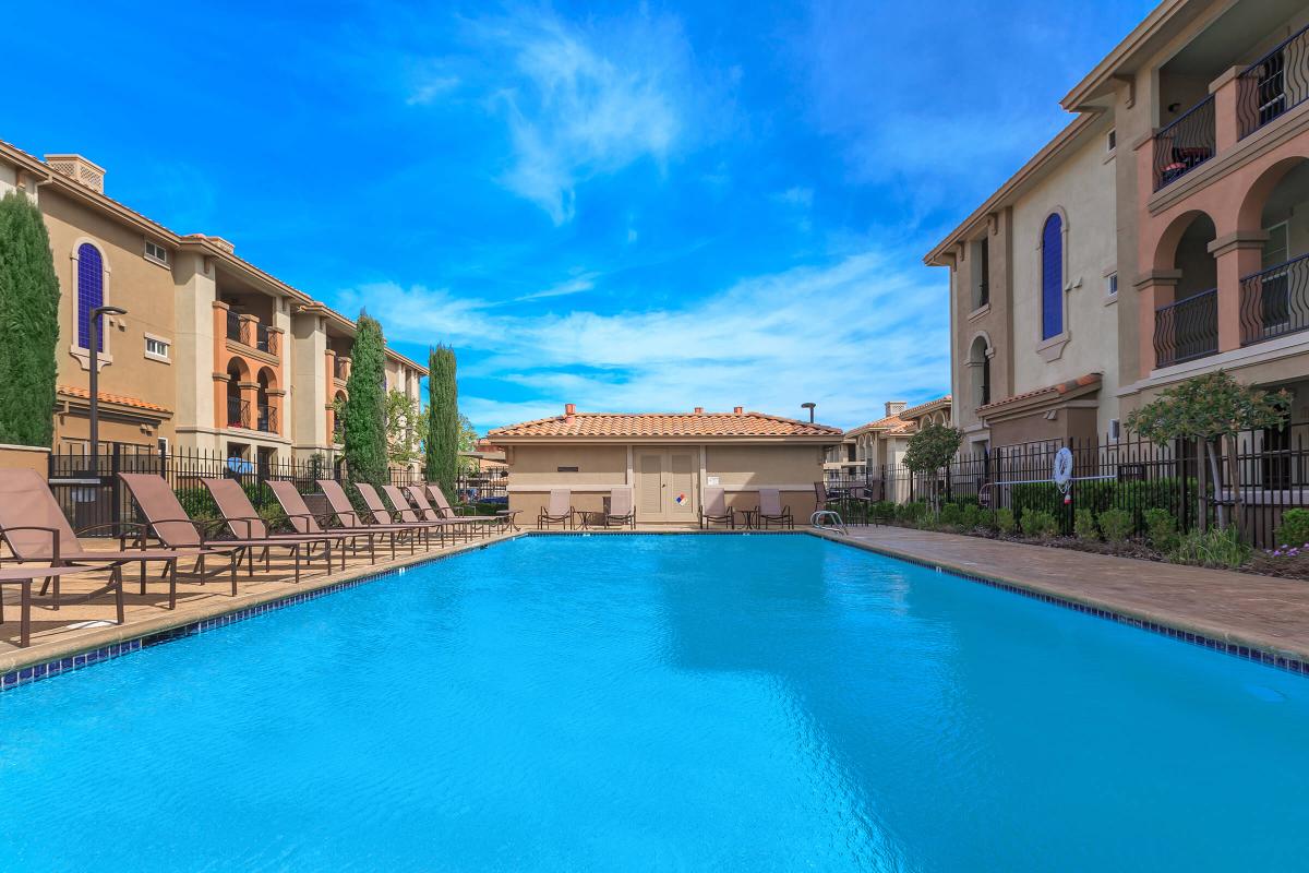 a large brick building with a pool of water