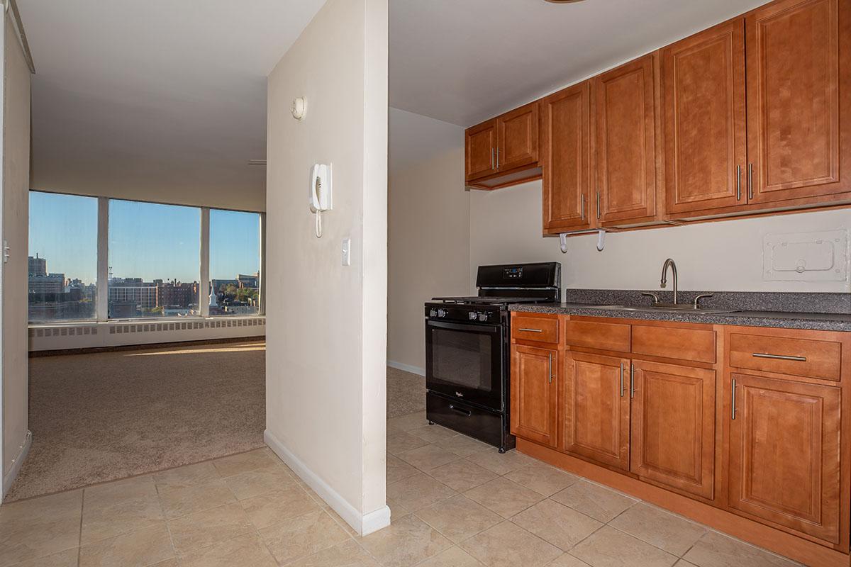 a large kitchen with stainless steel appliances and wooden cabinets