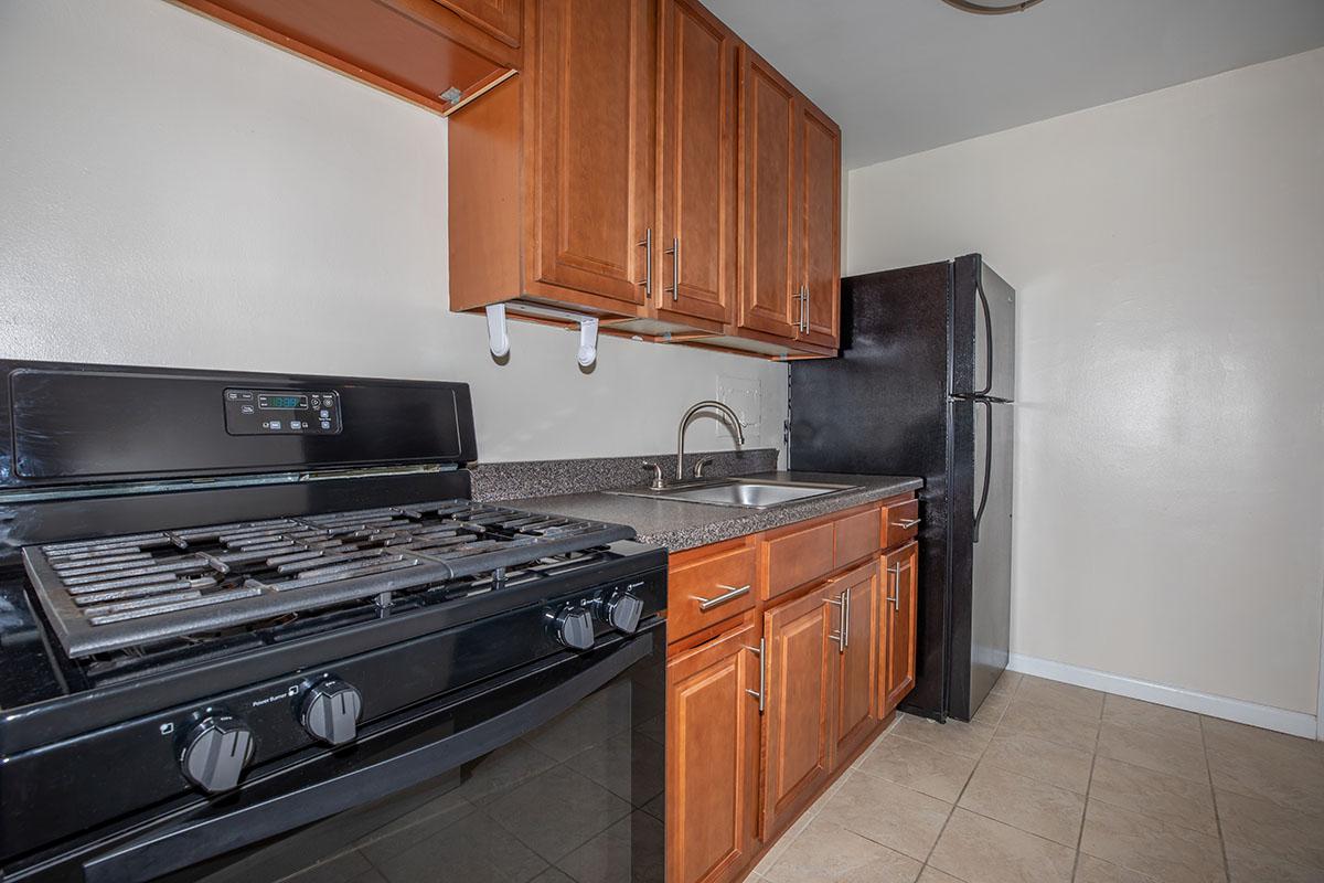 a kitchen with stainless steel appliances and wooden cabinets