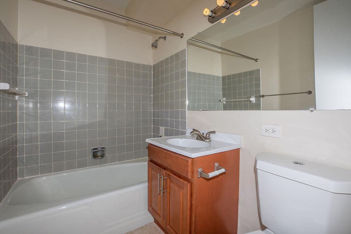 a white tub sitting next to a sink