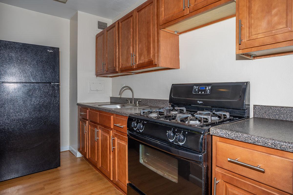 a kitchen with stainless steel appliances and wooden cabinets