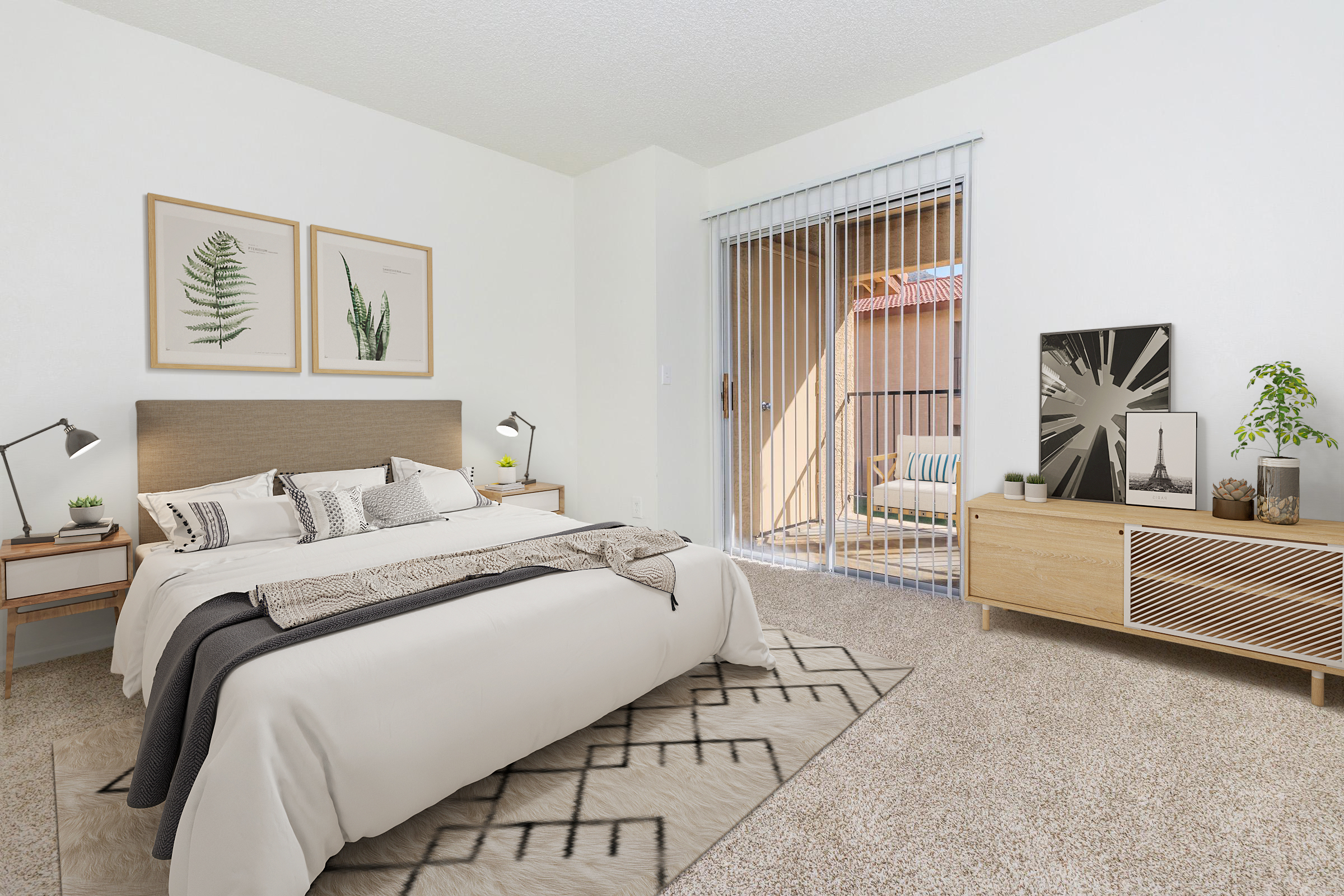 A modern bedroom featuring a queen-sized bed with decorative pillows and a cozy blanket, wooden nightstands with lamps on either side, and a large window with sliding doors leading to a balcony. There are framed botanical prints on the wall and a stylish media console with plants and a decorative item.