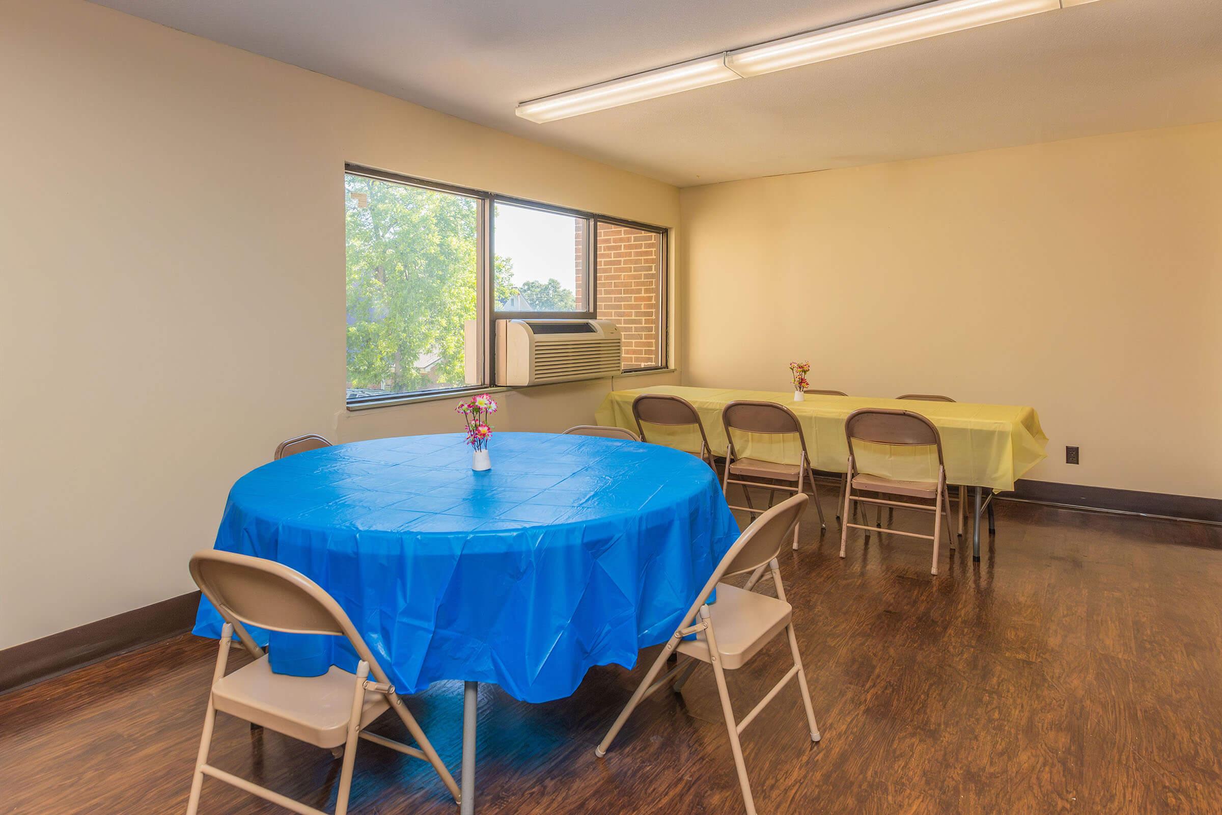 a dining room table with a blue chair