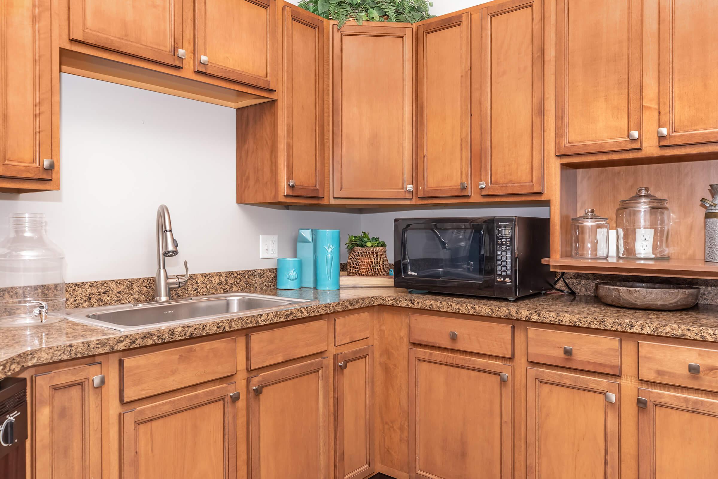 a kitchen with stainless steel appliances and wooden cabinets