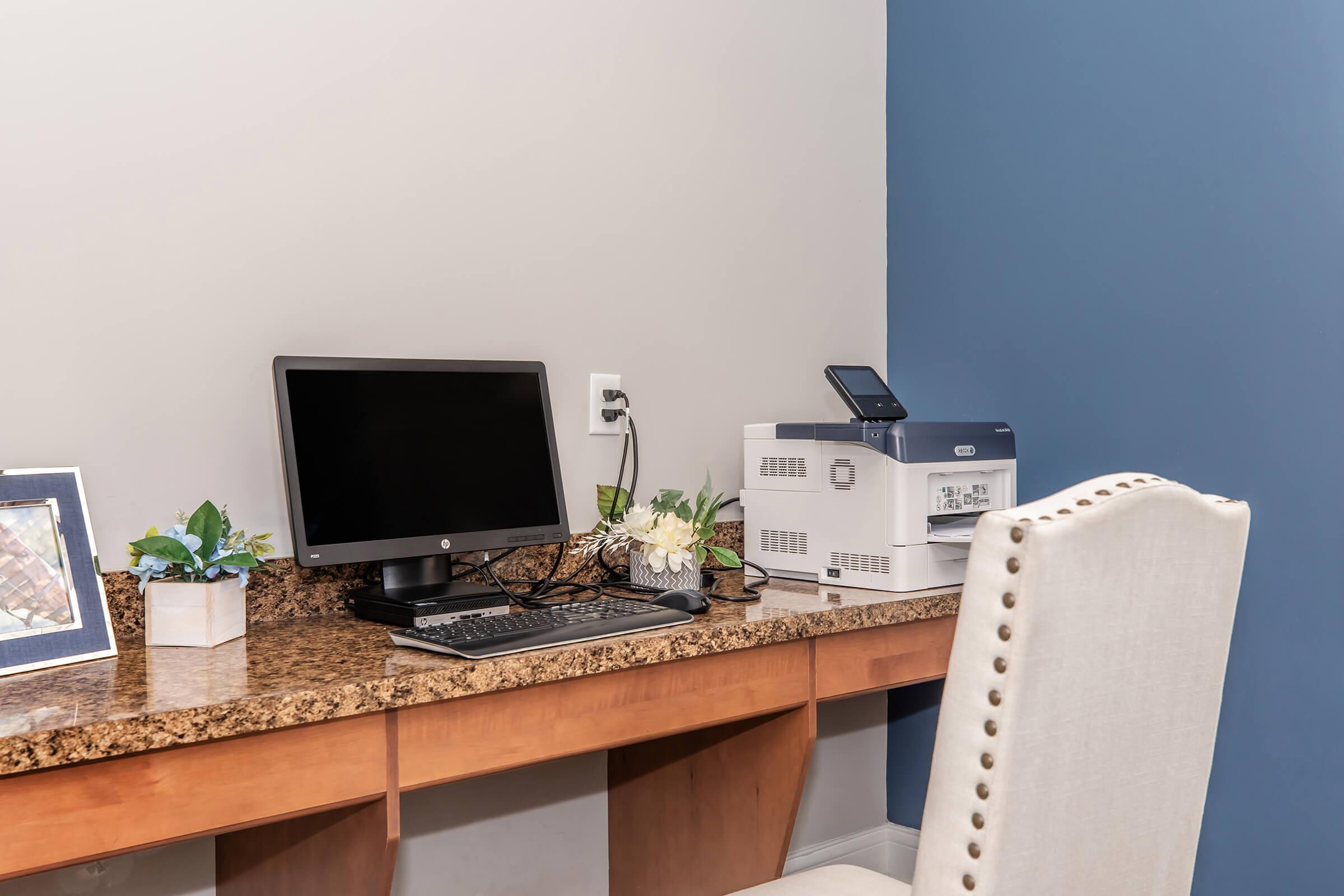 a desk with a computer on a table