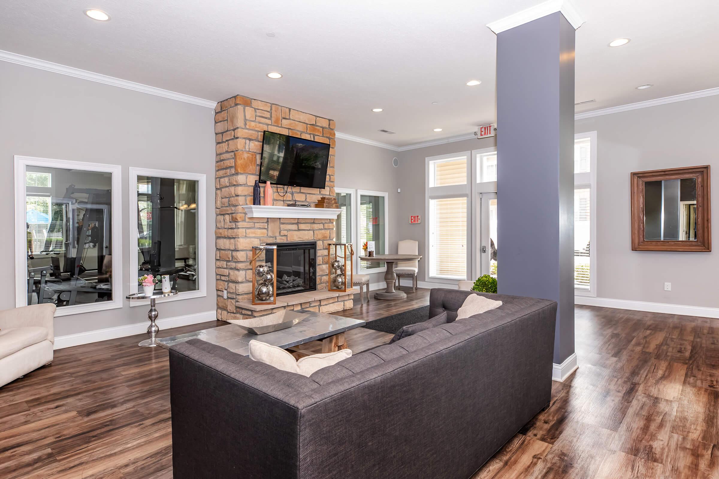 a living room filled with furniture and a flat screen tv