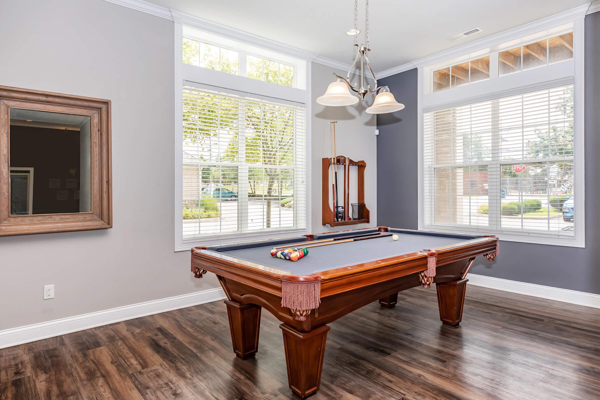 a room with wooden floors and a large window