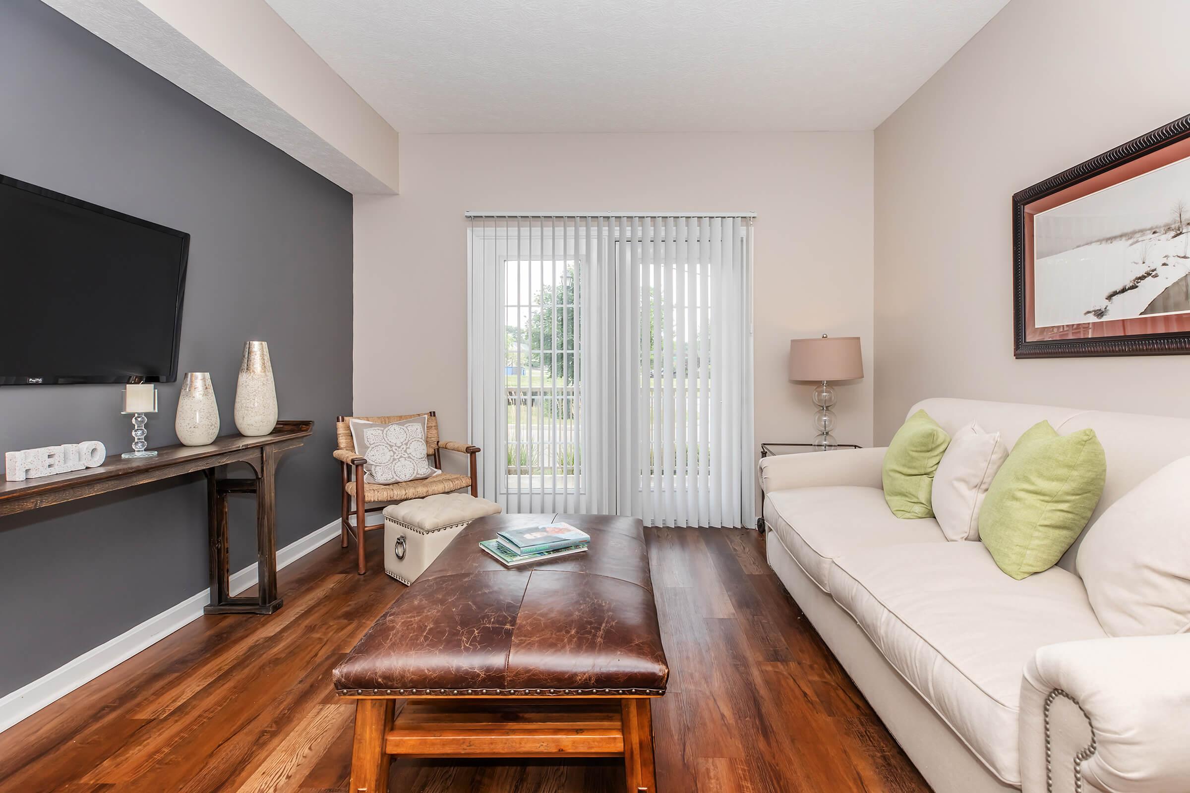 a living room filled with furniture and a large window