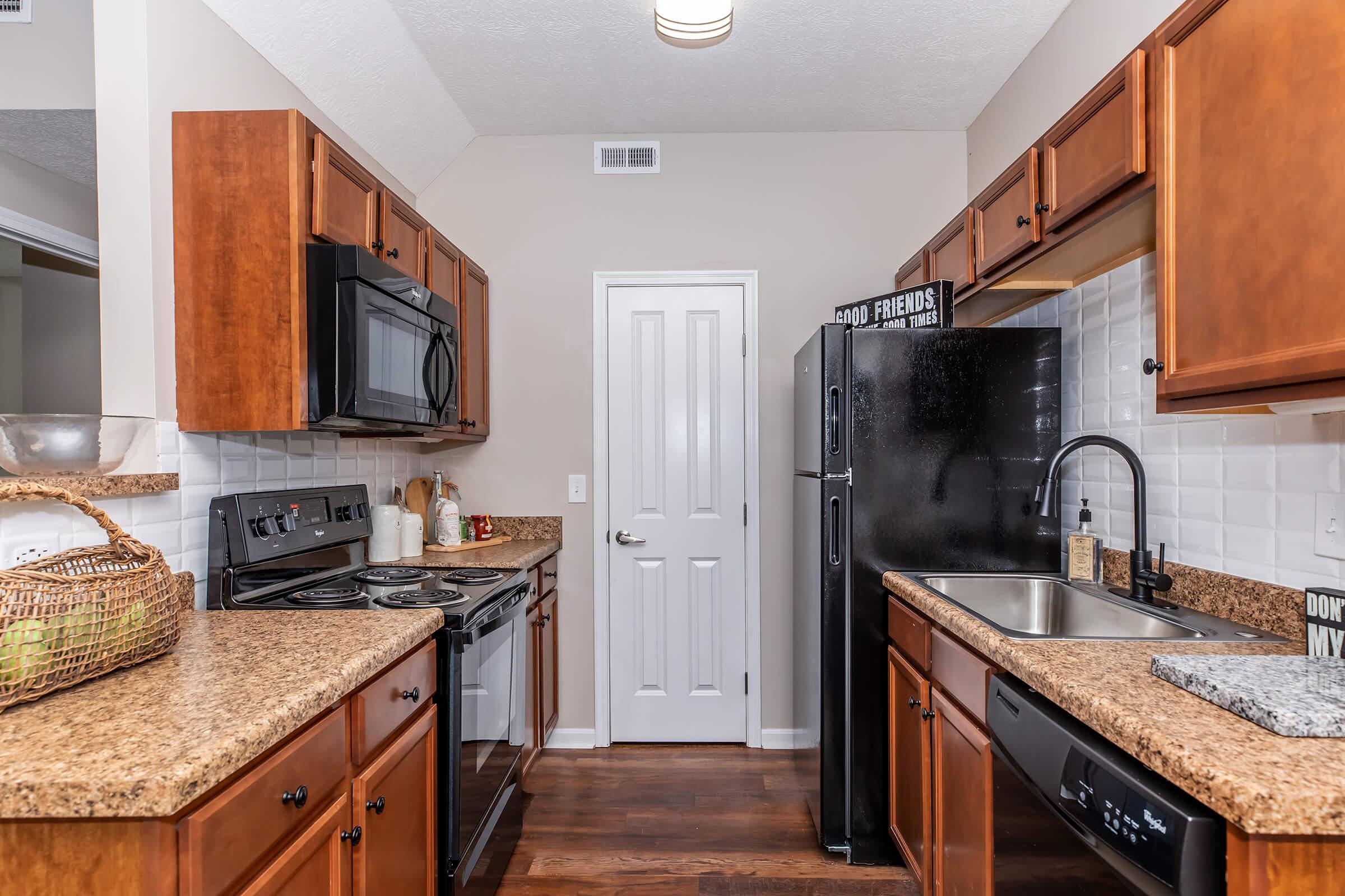 a modern kitchen with stainless steel appliances and wooden cabinets