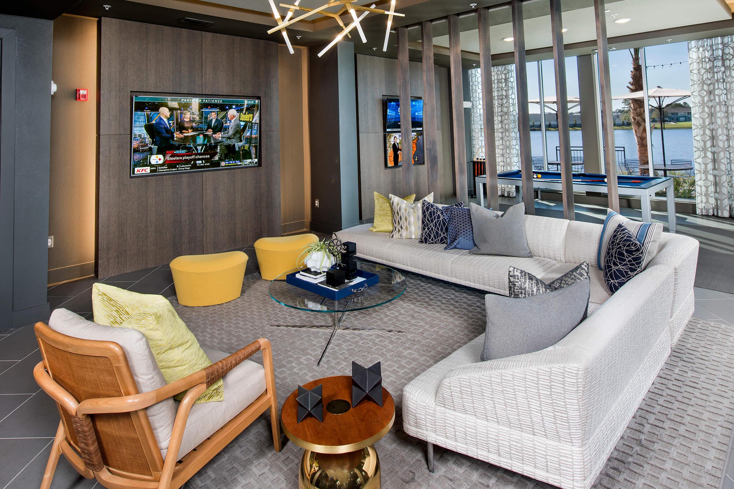 a living room filled with furniture and a large window