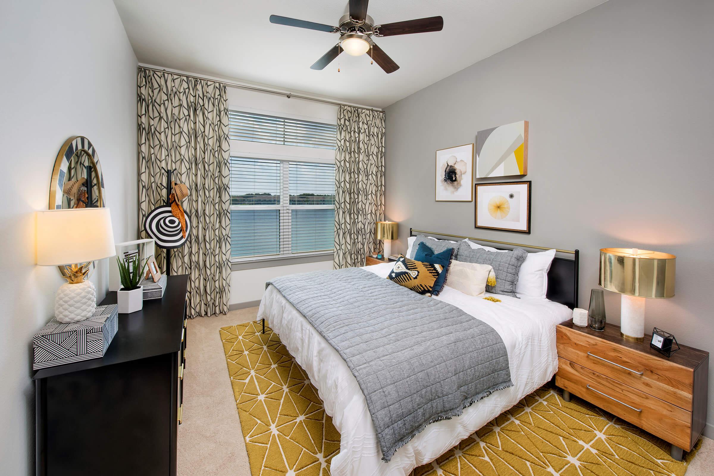 a bedroom with a bed and desk in a room