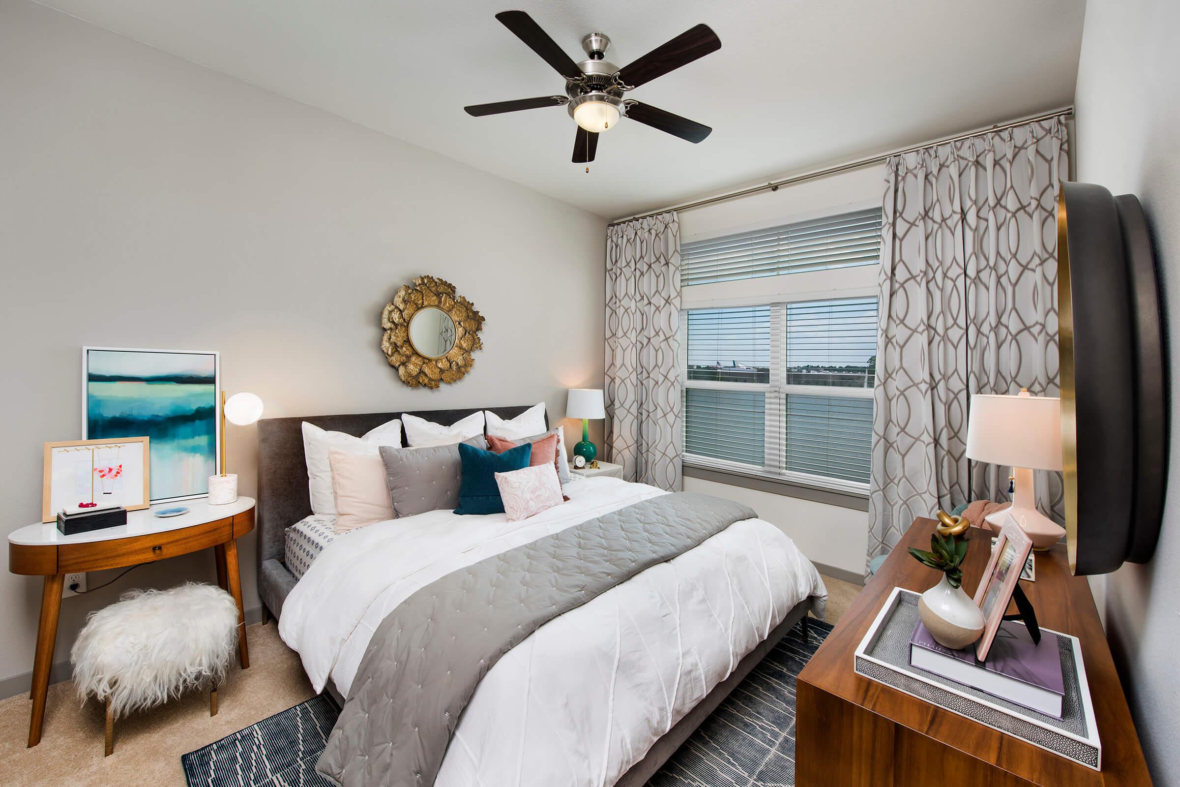 a bedroom with a bed and a chair in a room