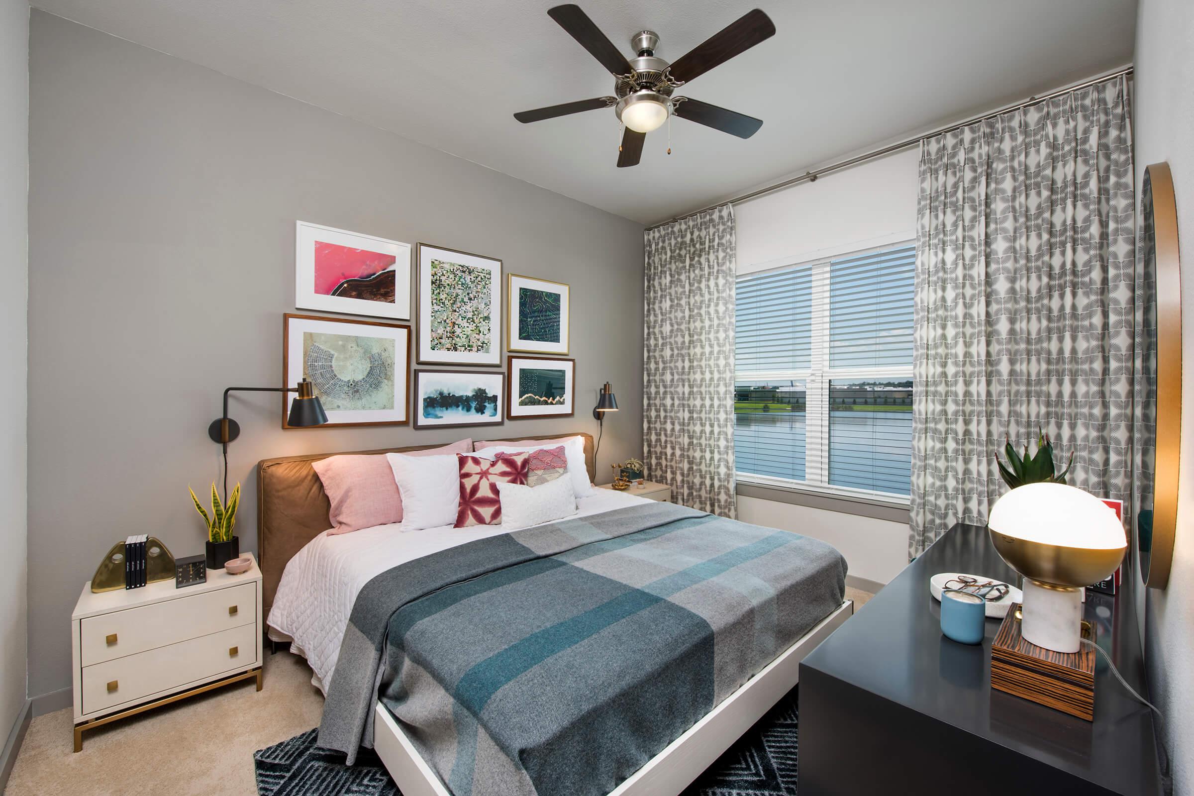 a bedroom with a bed and desk in a room