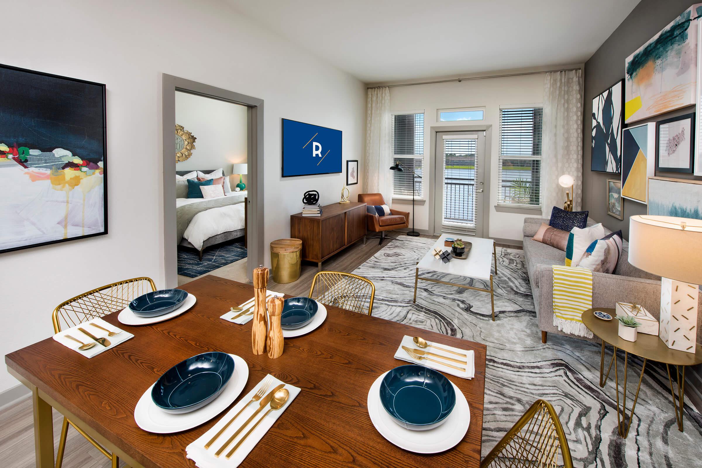 a living room filled with furniture and a large window